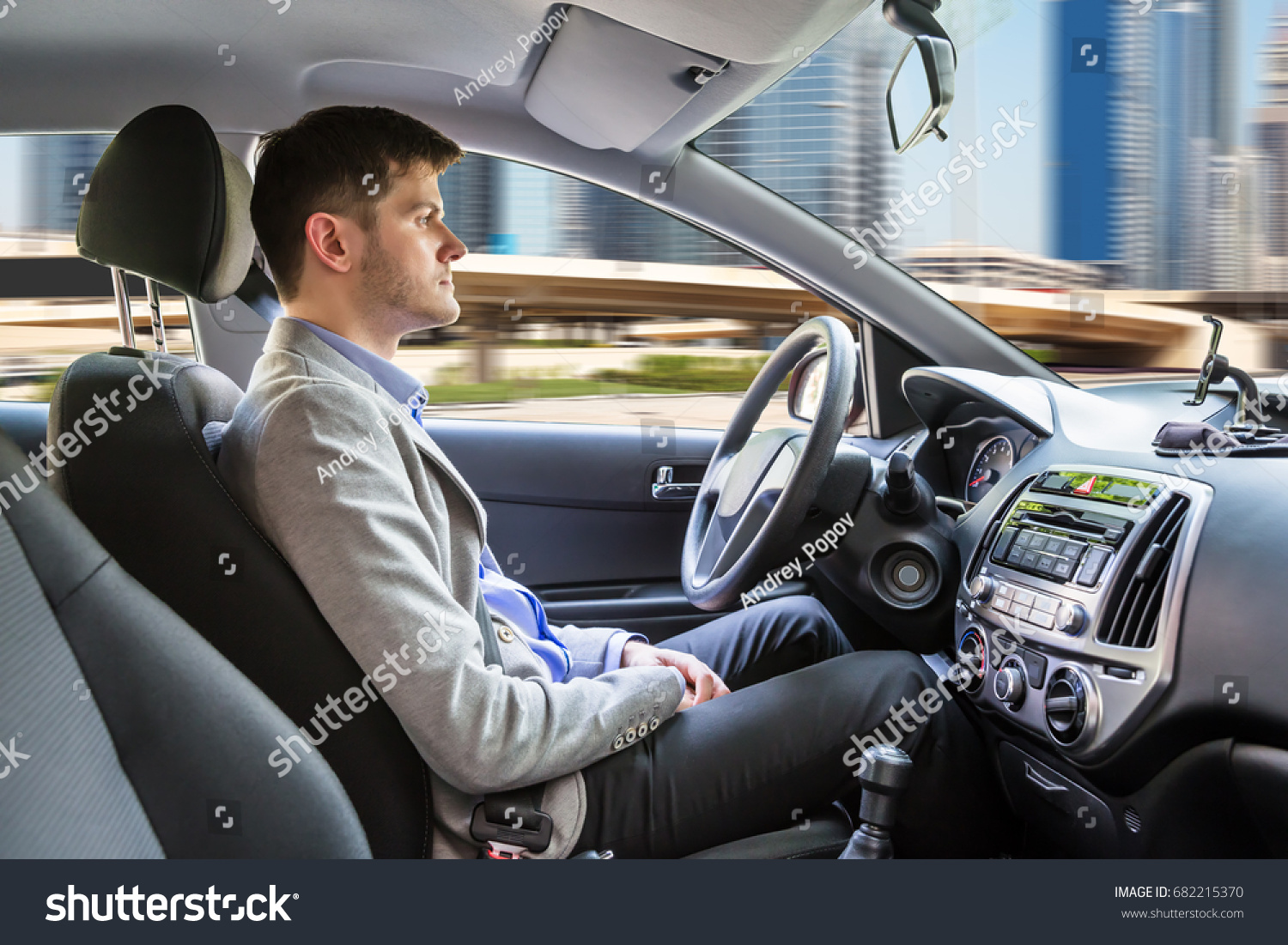 Side View Of A Young Man Sitting Inside Autonomous Car #682215370