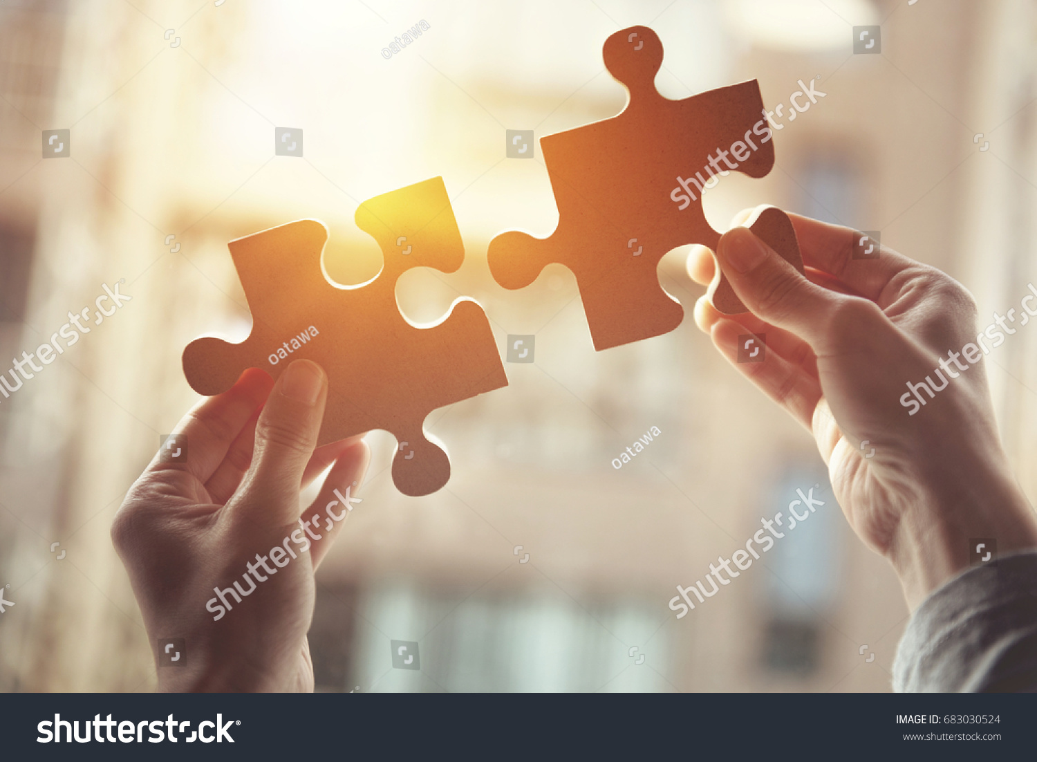 Closeup hand of woman connecting jigsaw puzzle with sunlight effect, Business solutions, success and strategy concept #683030524