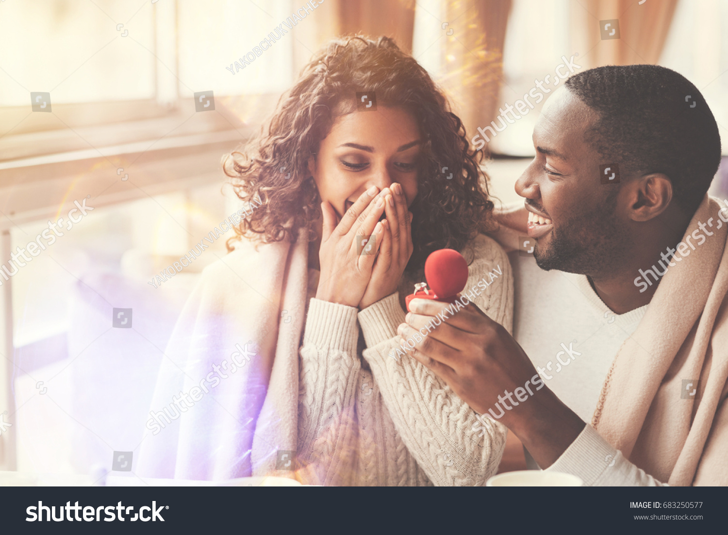 Cheerful handsome man proposing to his girlfriend #683250577