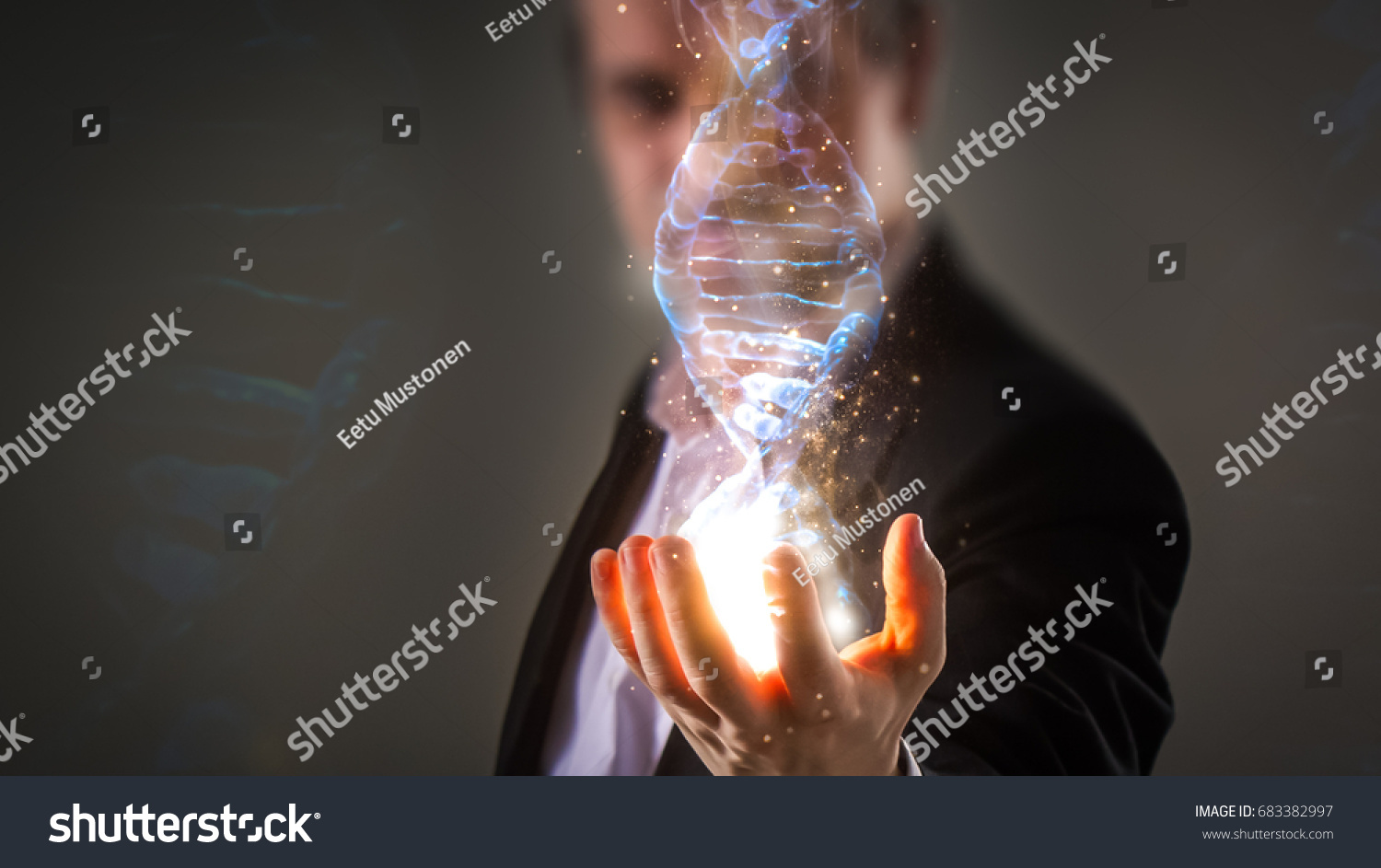 close up of Businessman holding glowing DNA helix with energy sparks - business, creation, genetics, future and science concept #683382997