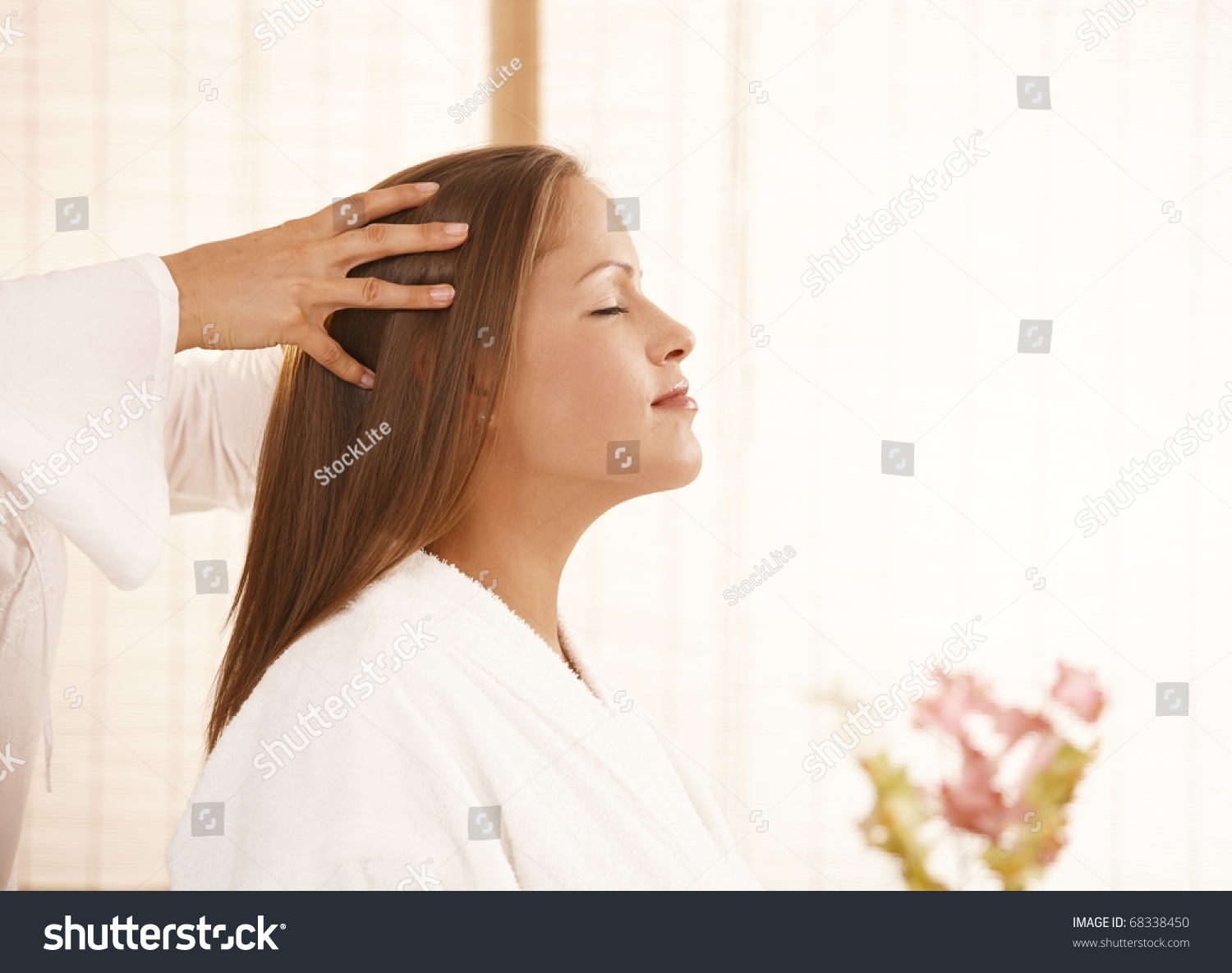Portrait of young woman enjoying head massage with closed eyes, smiling. #68338450