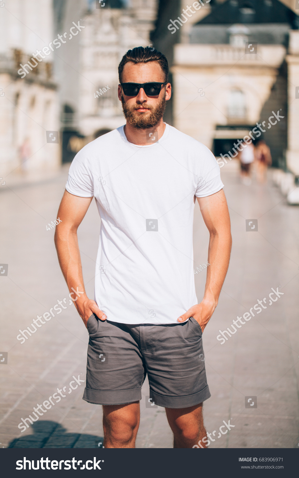 Hipster handsome male model with beard  wearing white blank  t-shirt with space for your logo or design in casual urban style #683906971