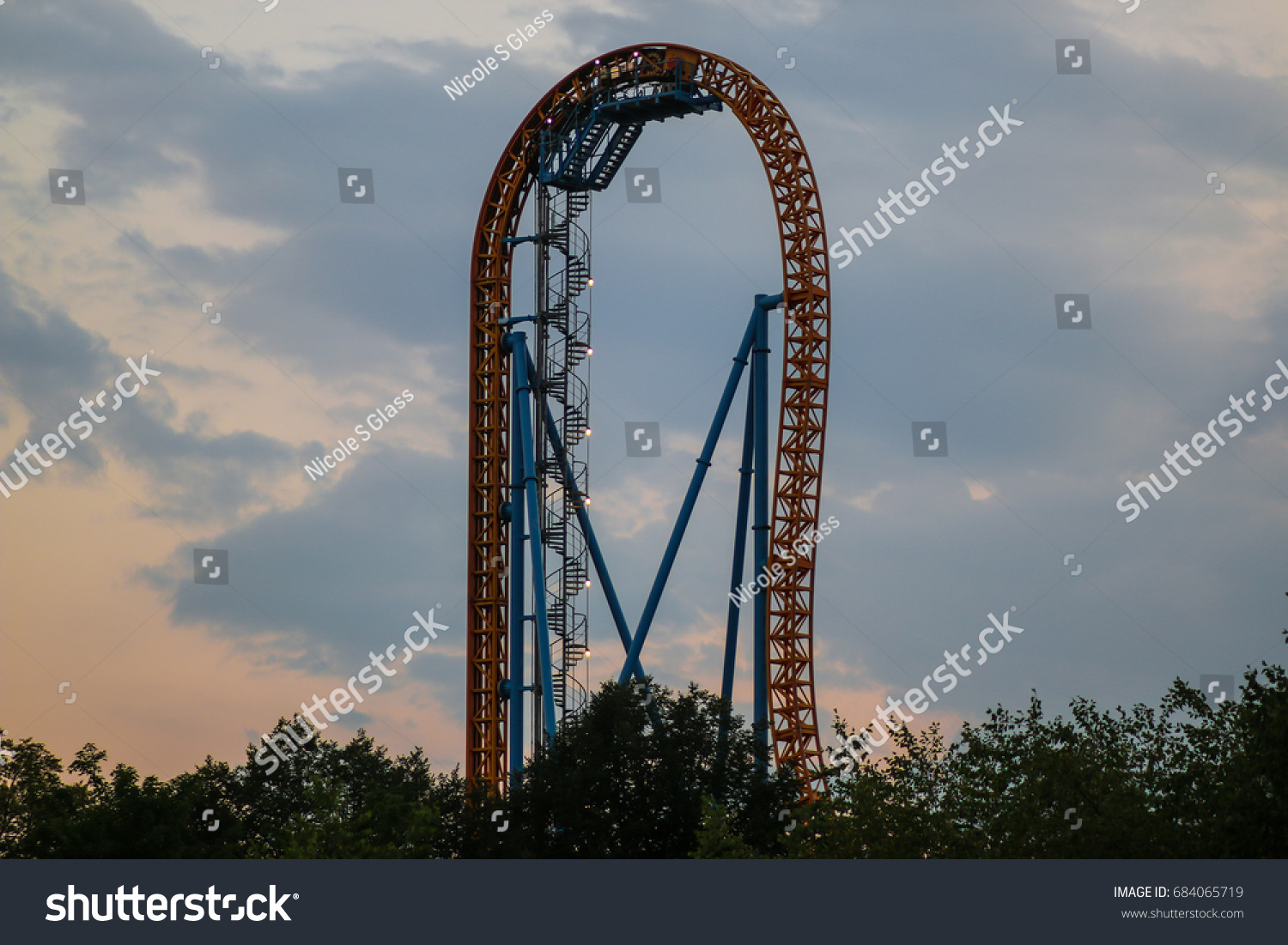 Hershey, PA - July 24, 2017: A view of a roller coaster ride at Hersheypark at sunset. #684065719