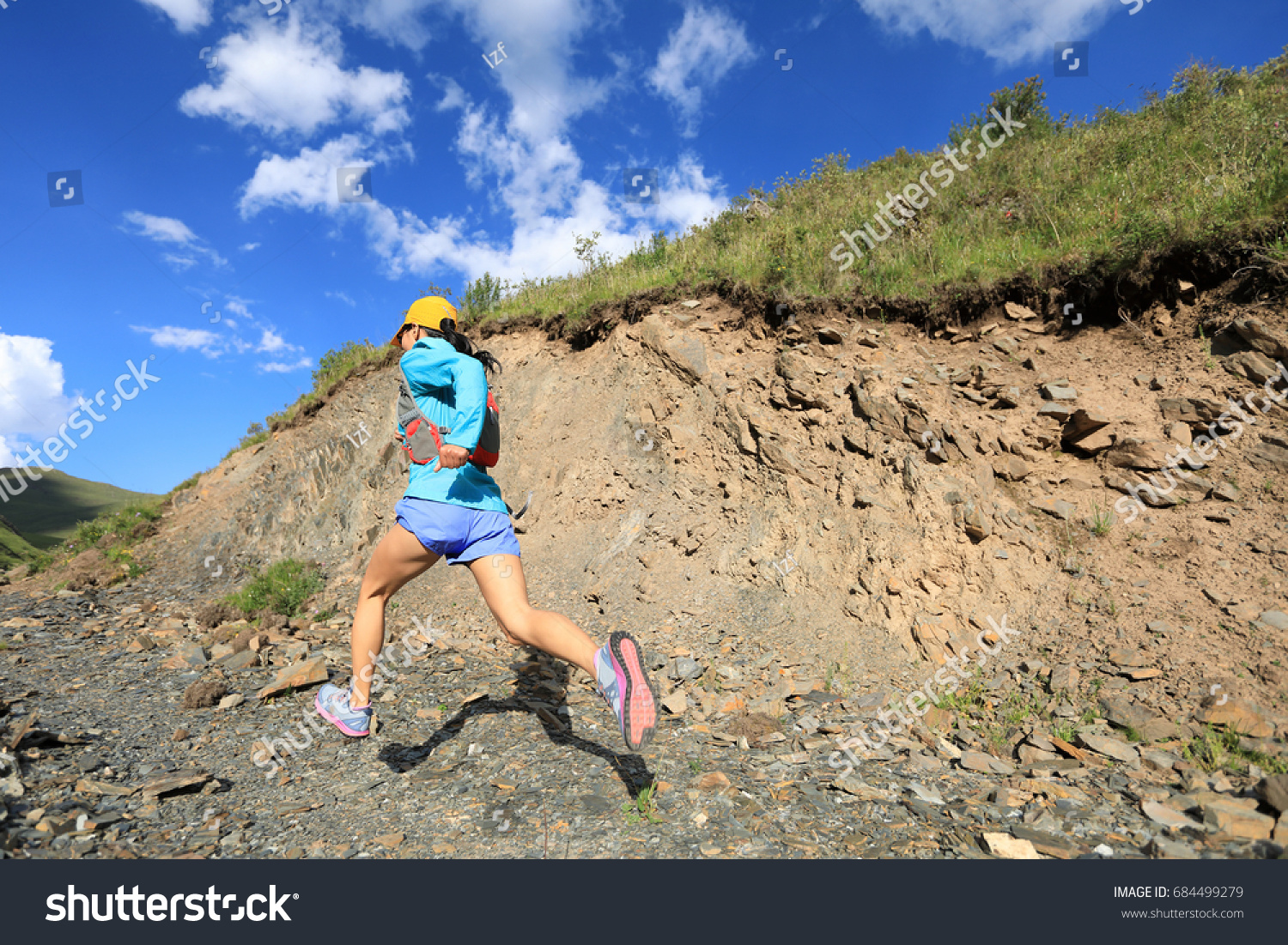 young fitness woman trail runner running in the nature #684499279
