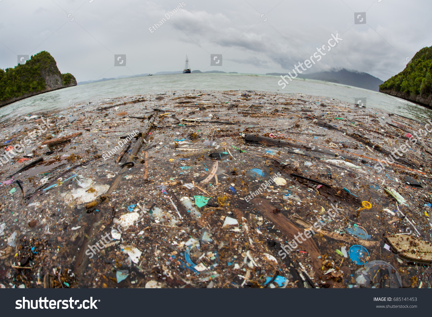 Discarded plastic has washed up near a remote island in Raja Ampat, Indonesia. Plastic is an ever-growing danger to marine ecosystems throughout the world. #685141453