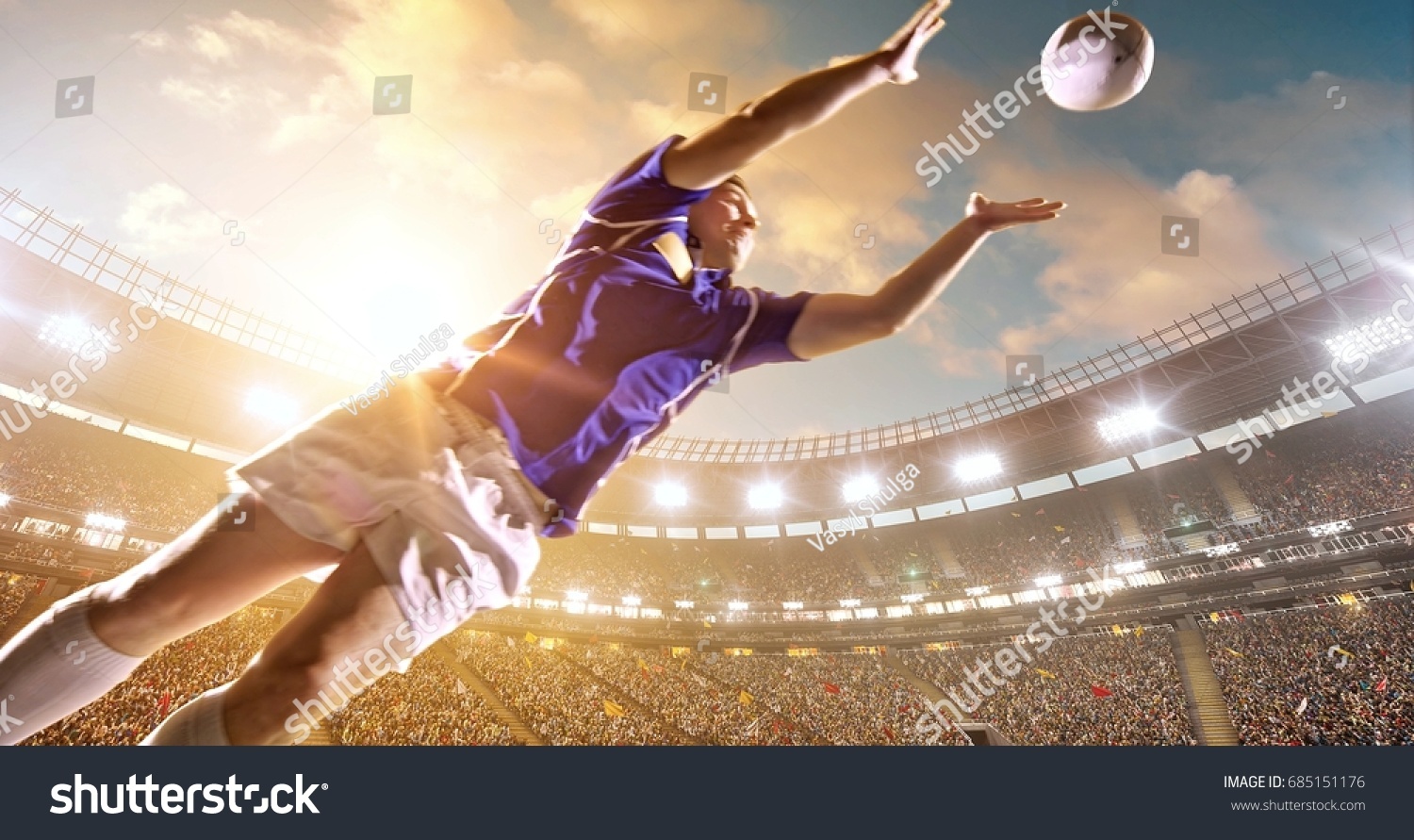 Professional rugby player jumps with a ball on a professional sports arena with bleaches full of people. Arena and people on it are made in 3D.
 #685151176