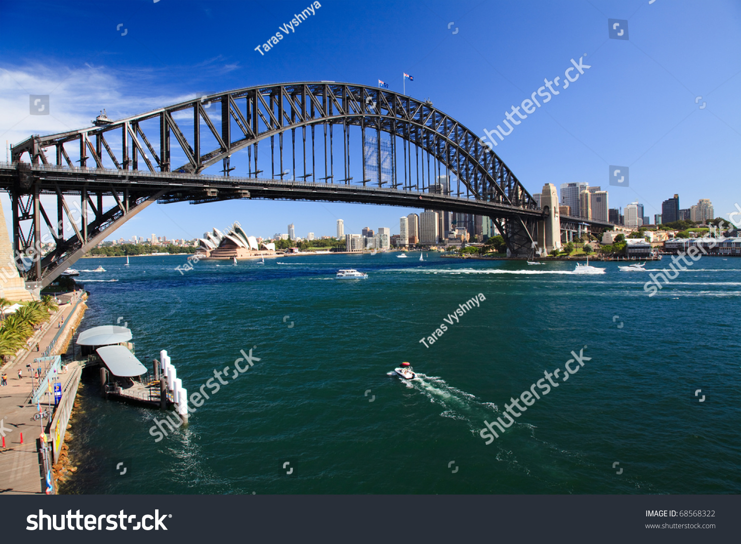 View on Harbour Bridge arch over harbour Sydney Australia and opera house from Luna park attraction sunny summer day #68568322