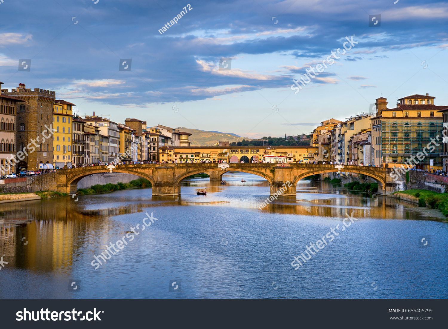 Florence cityscape view with Ponte Vecchio, a medieval stone bridge over Arno River. #686406799