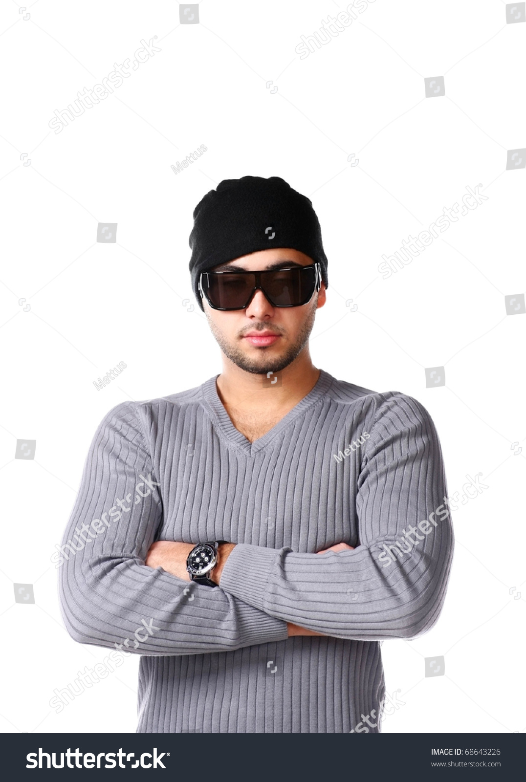 Cool Latino Man Dressed In Grey Pullover, Trendy Sunglasses And Beanie Hat, unshaven guy 
with short bristles on the face. #68643226