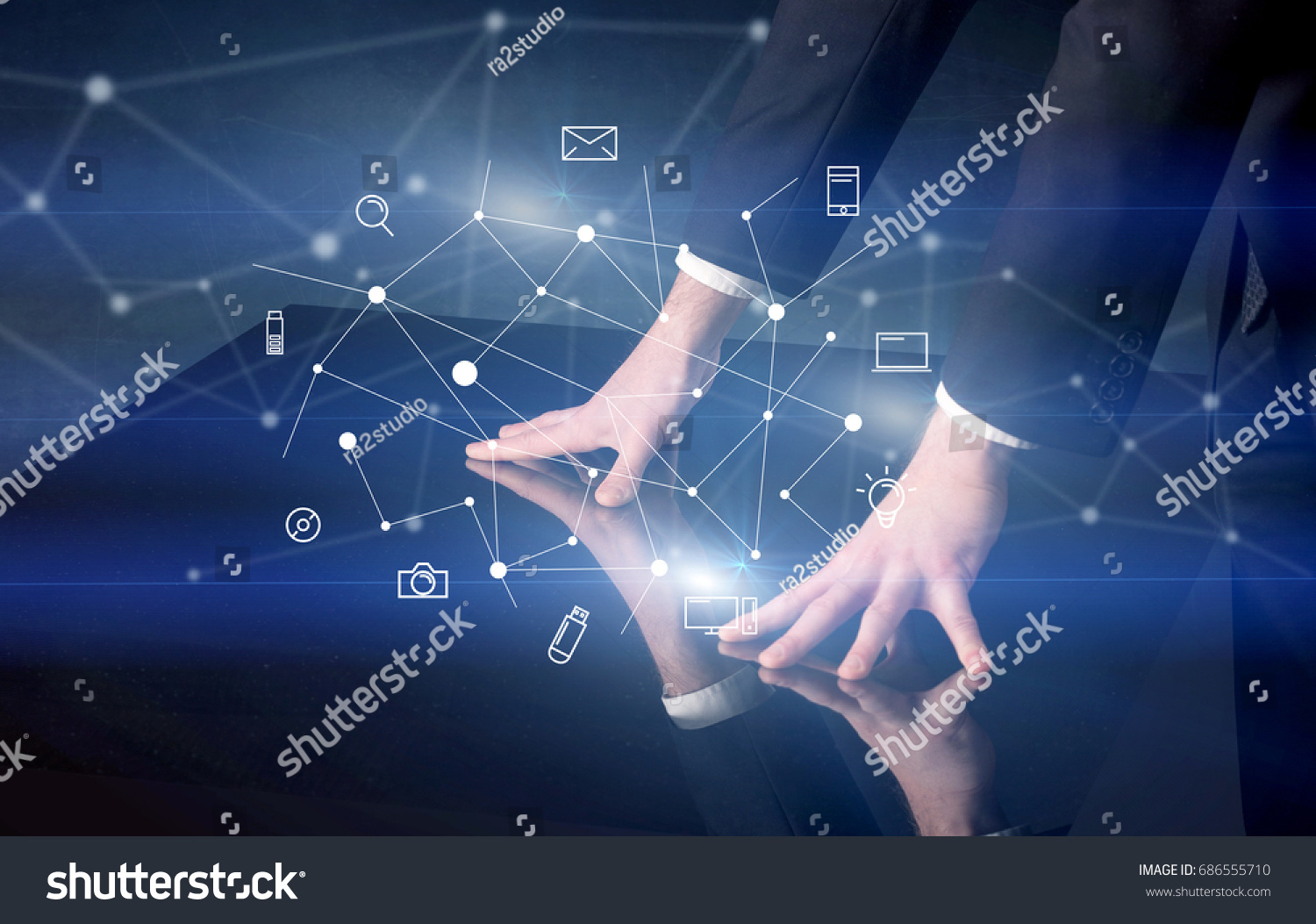Male hands touching interactive table with blue mixed communication icons in the background #686555710