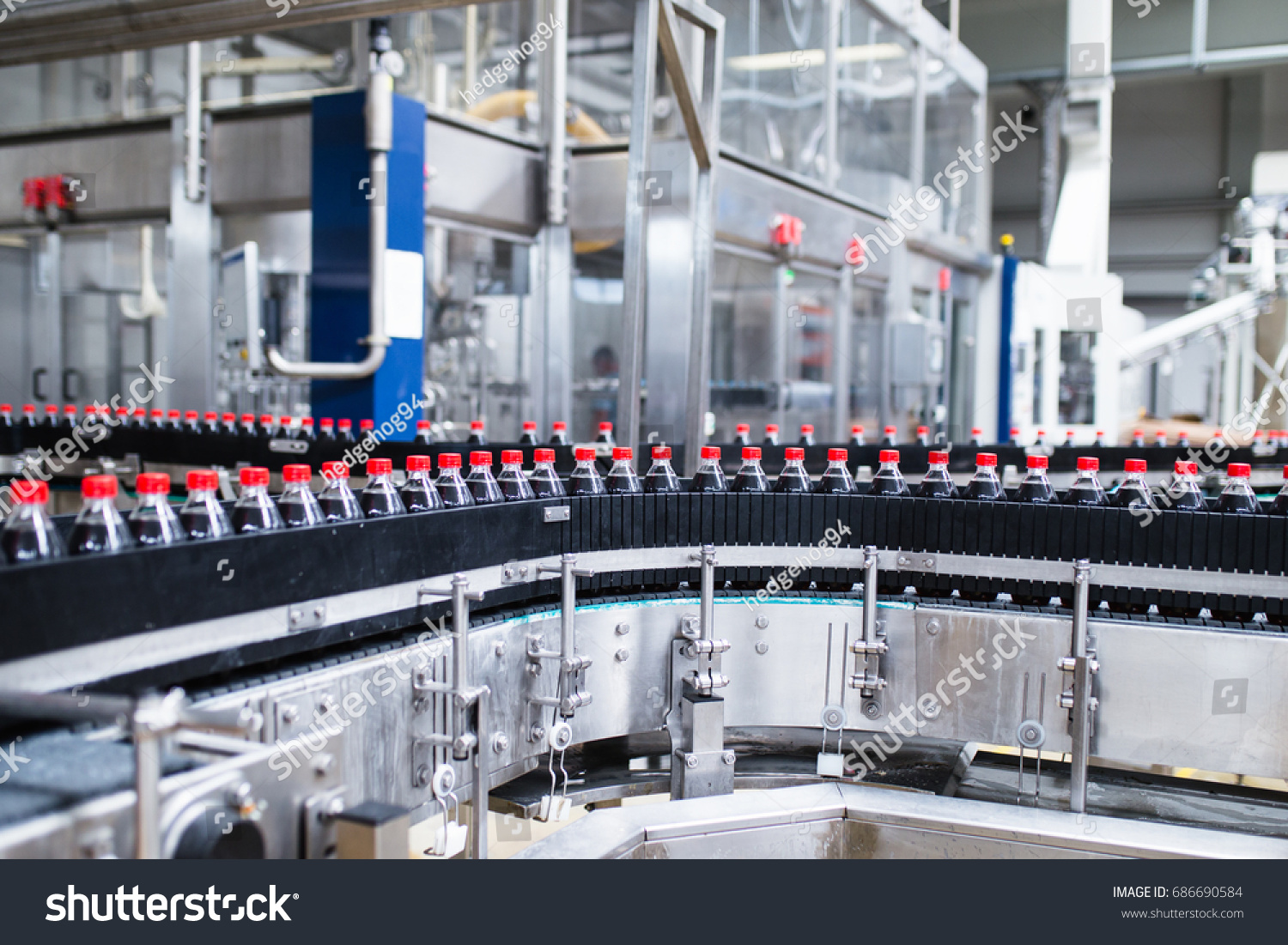 Bottling factory - Black juice bottling line for processing and bottling juice into bottles. Selective focus.  #686690584