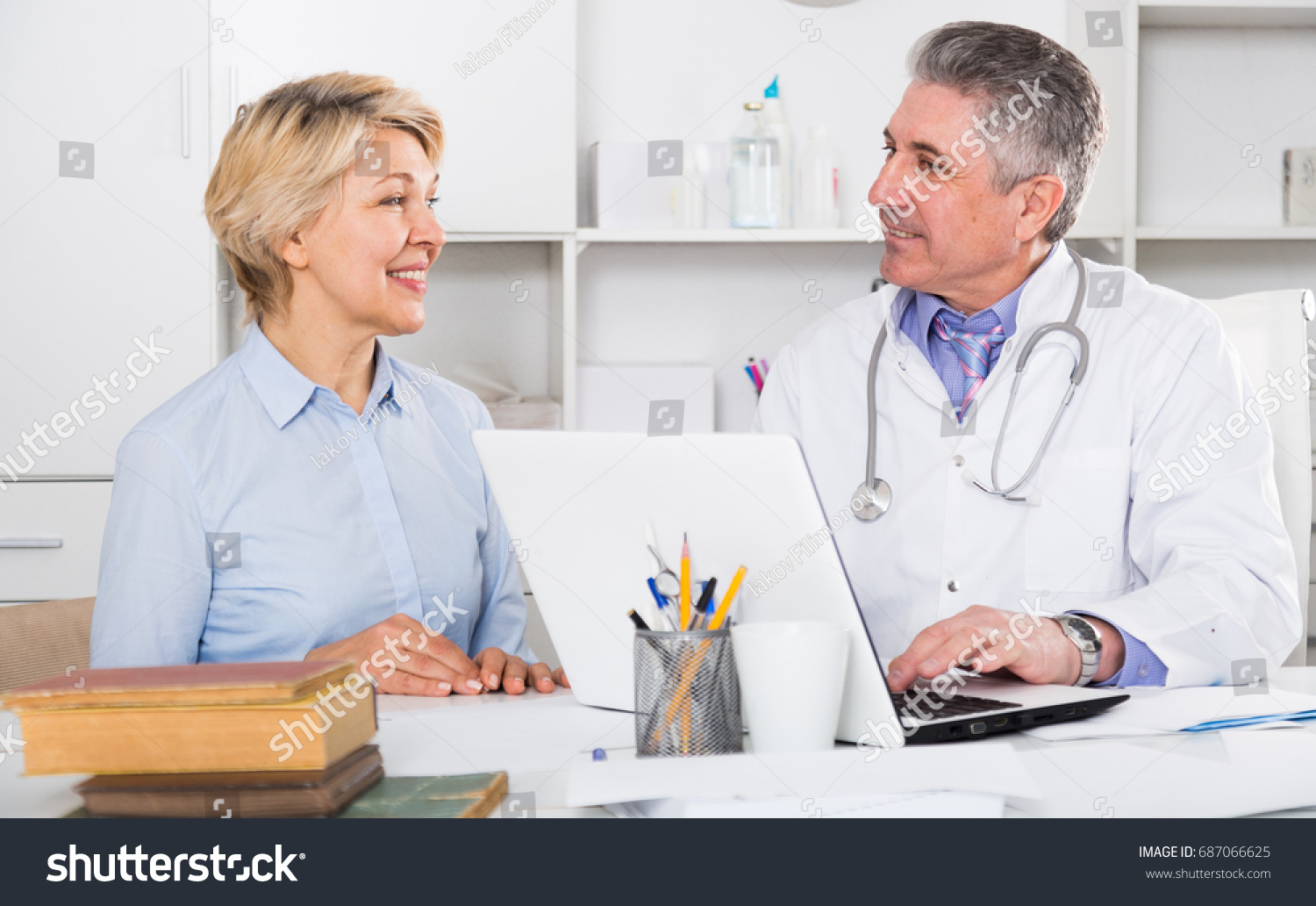 Mature woman visits doctor to medical office for planned inspection of health #687066625