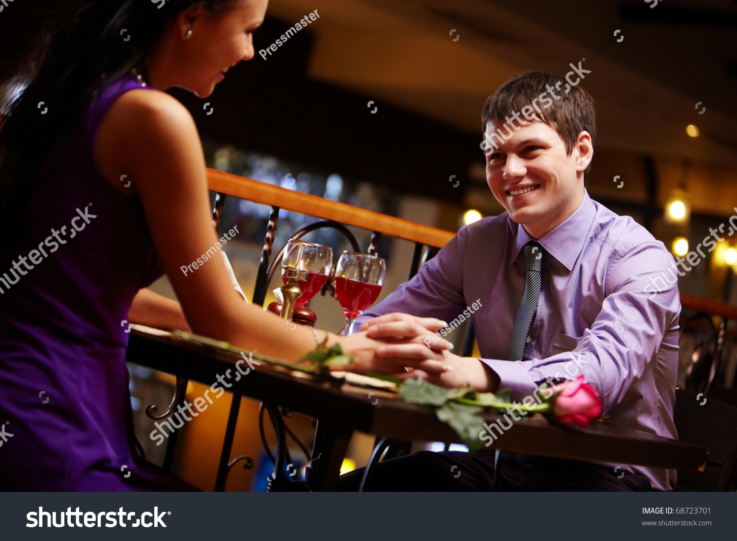 Portrait of amorous couple holding by hands in the cafe #68723701