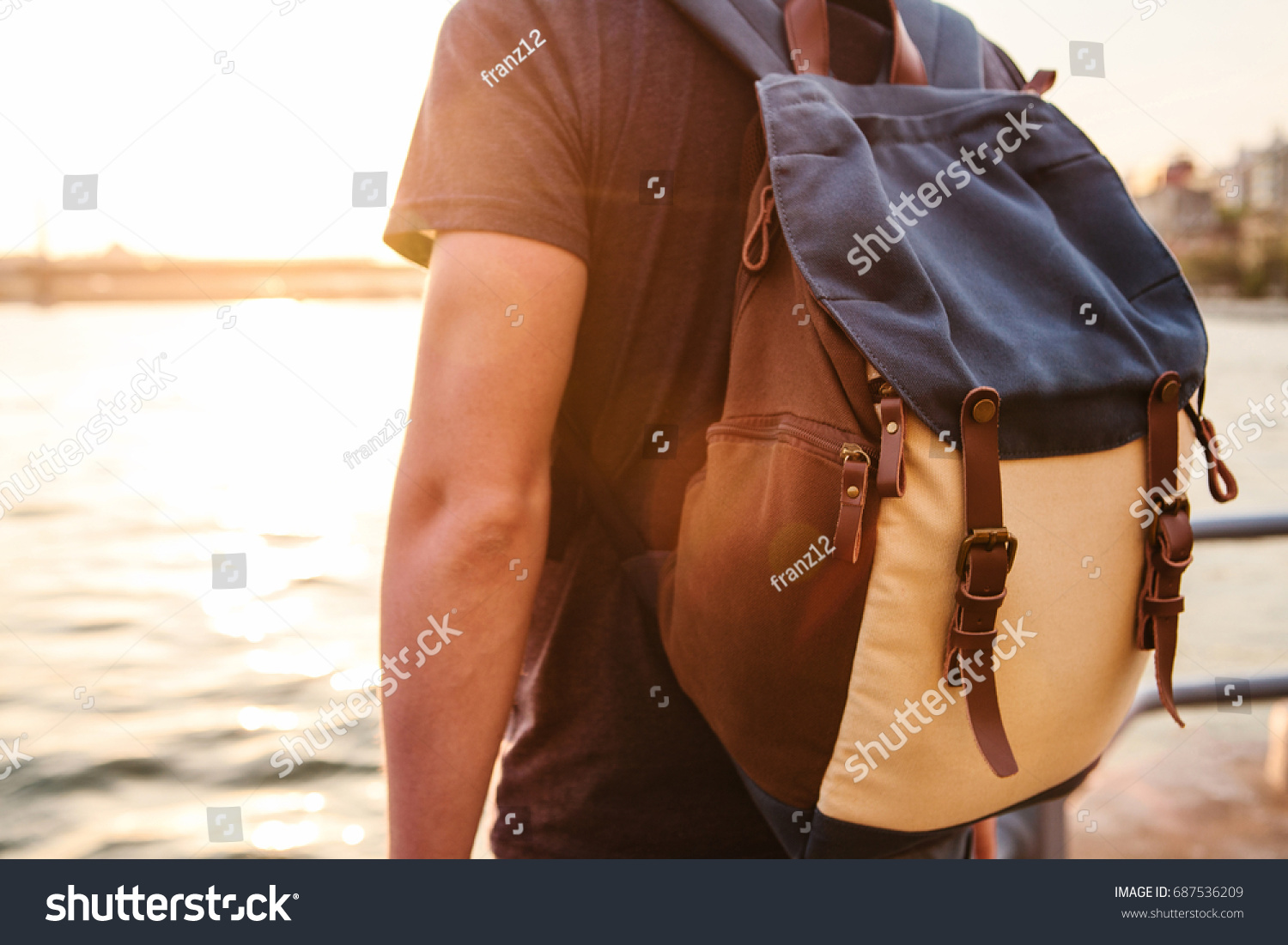 Male tourist with a backpack at sunset next to the Bosphorus in Istanbul. The concept of leisure, hiking, vacations. #687536209