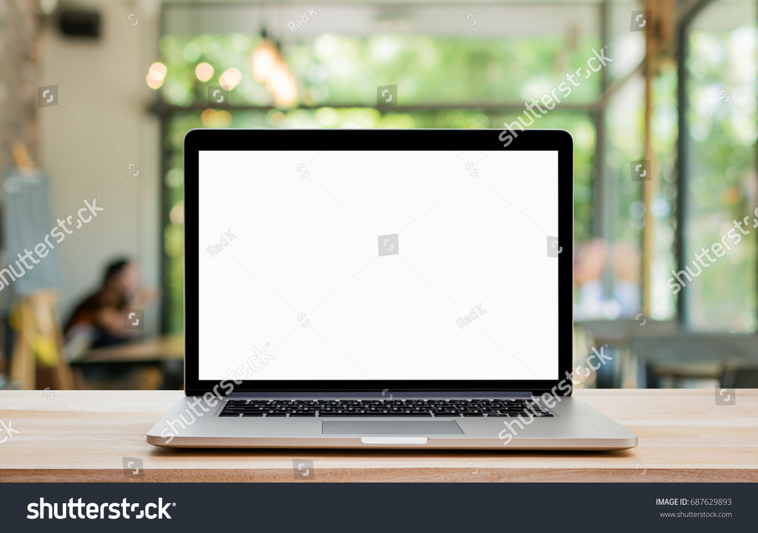 Laptop with blank screen on wood table and coffee shop background. Clipping path include. #687629893