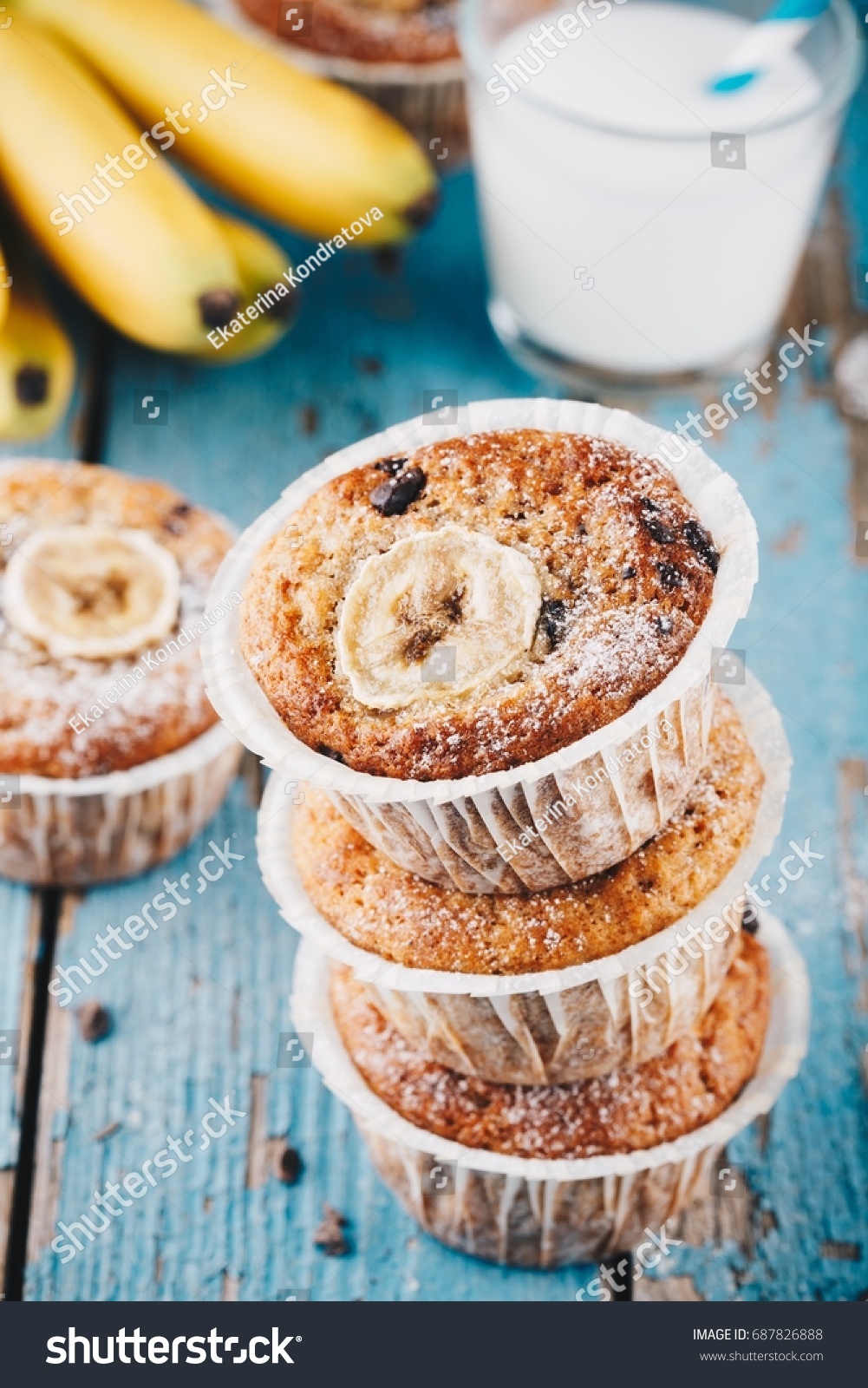 chocolate chips banana muffins on rustic background #687826888