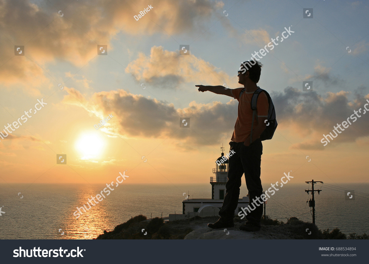 Mediterranean sunset at the Akrotiri Lighthouse in Santorini, Greece. #688534894