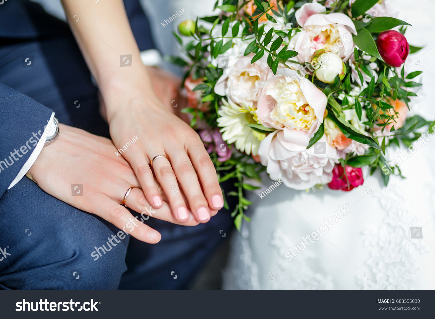 Wedding details. Hands of the newlyweds. Bride rings on hands. #688555030