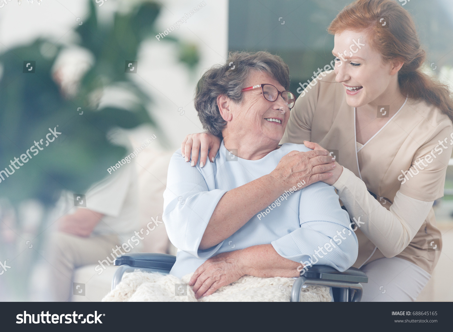 Happy patient is holding caregiver for a hand while spending time together #688645165