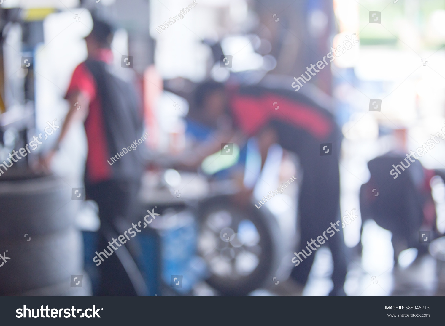 Abstract blur section of technician repairing the car to change at wheel in garage. #688946713