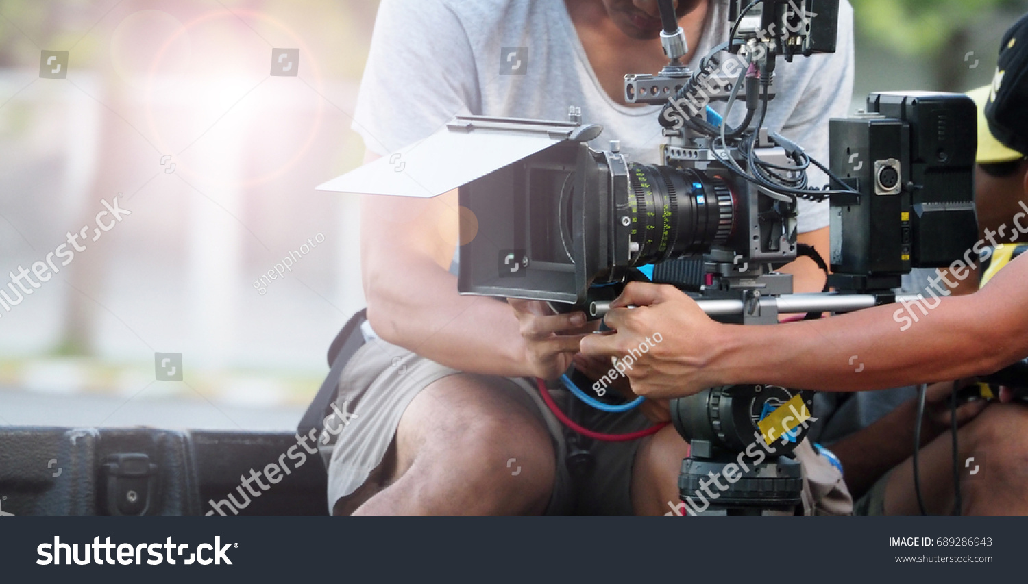 Behind the scenes of movie shooting or video production and film crew team with camera equipment at outdoor location. #689286943