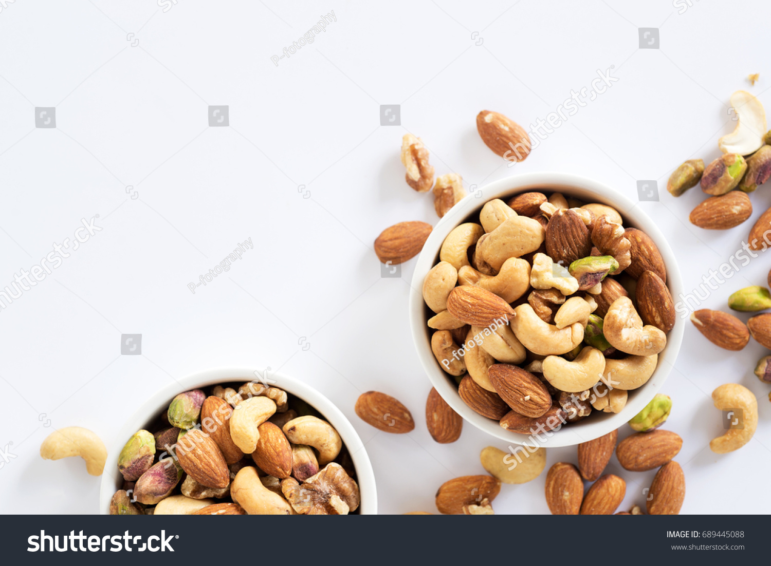 mixed nuts in white ceramic bowl  #689445088