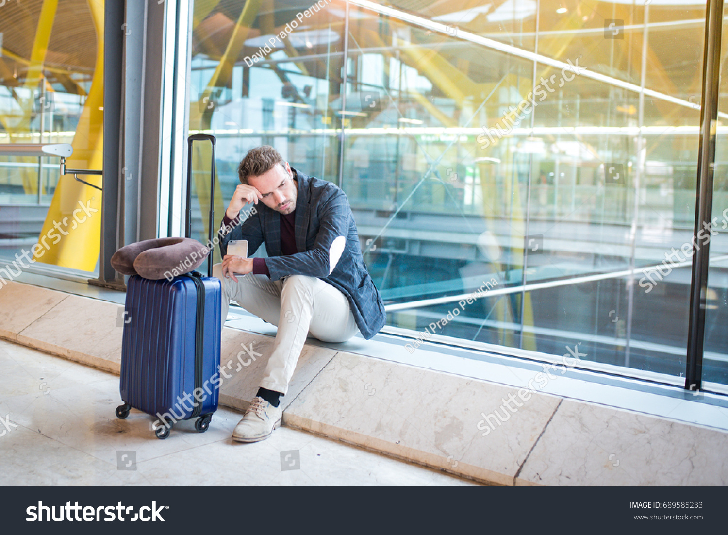 Man upset at the airport his flight is delayed #689585233