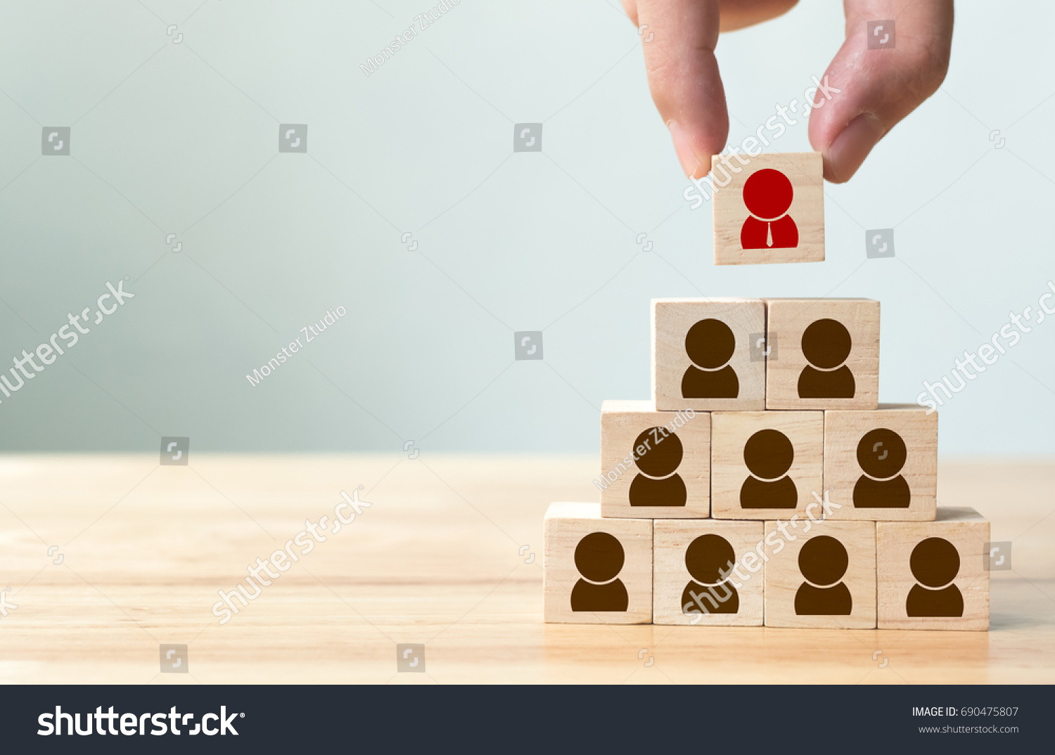 Human resource management and recruitment business concept, Hand putting wood cube block on top pyramid, Copy space #690475807