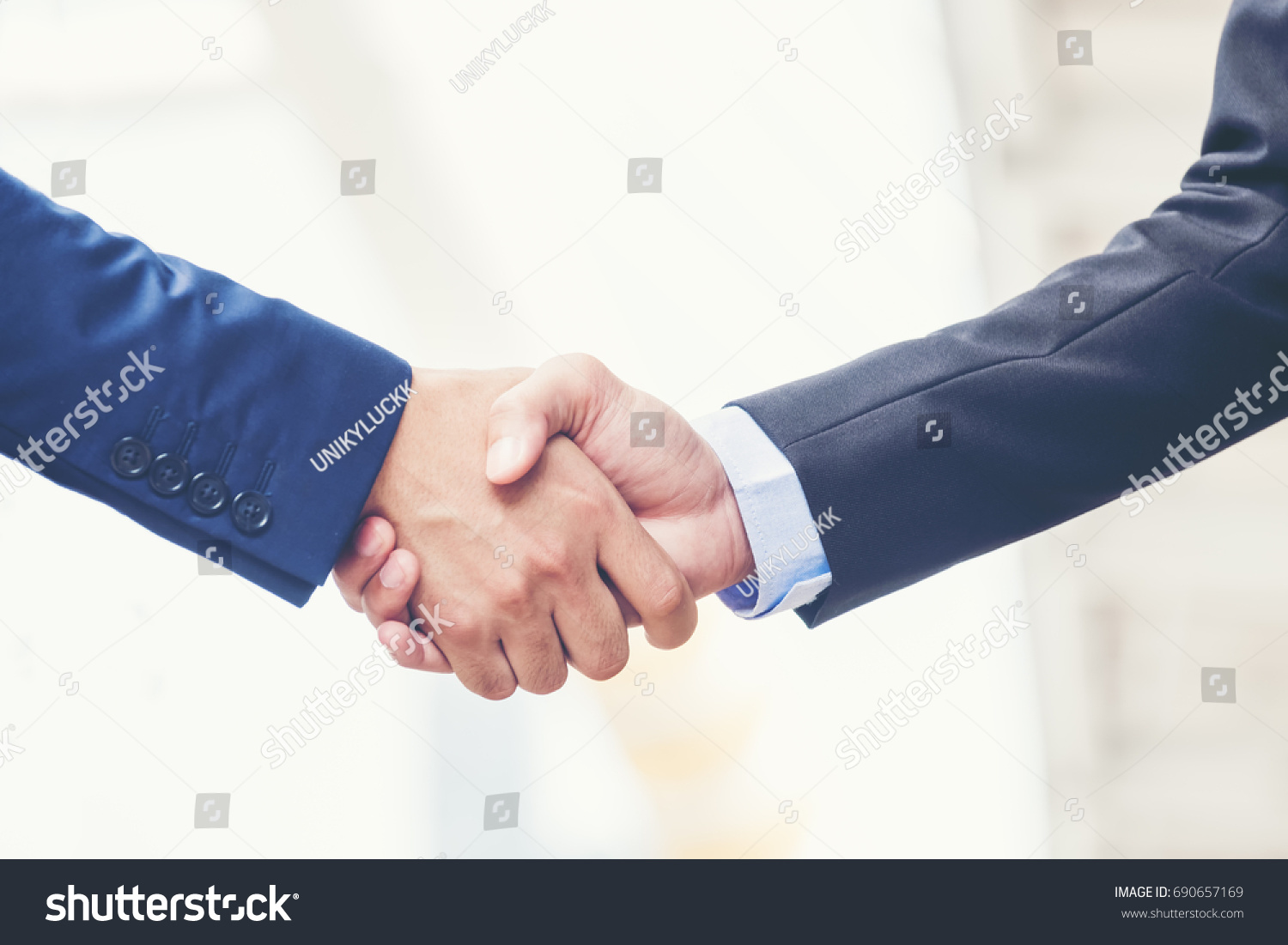 Business partnership meeting concept. Image businessmans handshake. Successful businessmen handshaking after good deal. Horizontal, blurred background #690657169