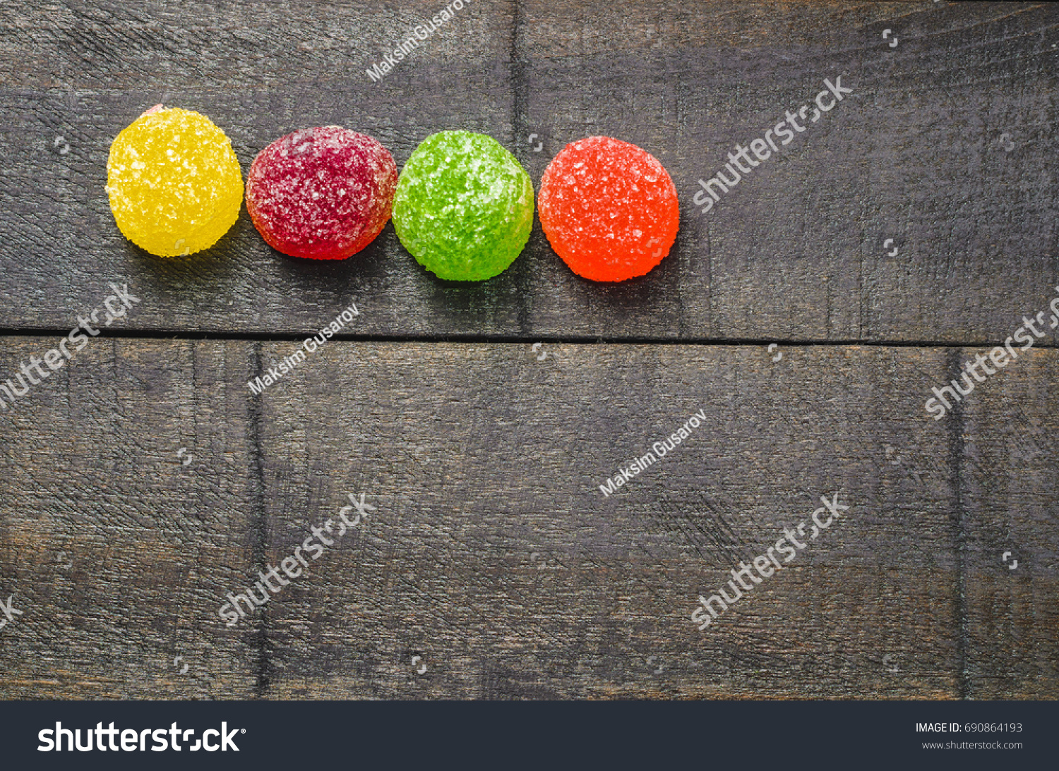 Bright colored candy, sweets, sweets on a dark background, top view #690864193