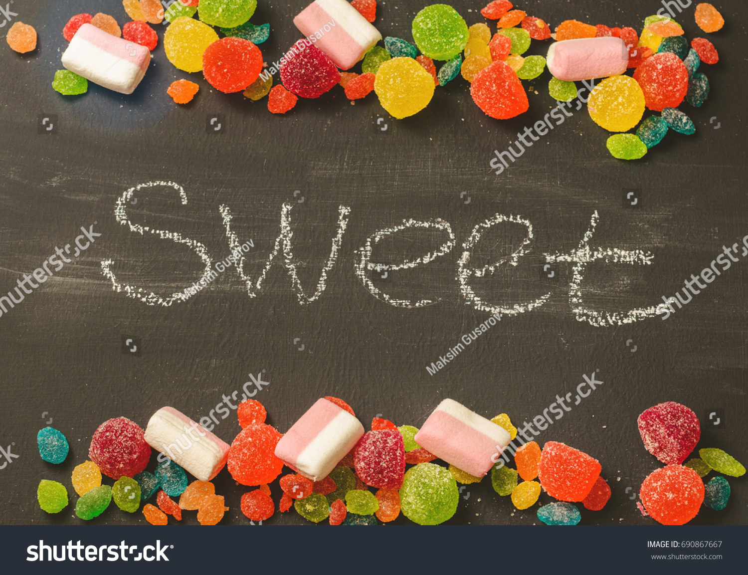 Bright colored candy, sweets, sweets on a dark background, top view #690867667
