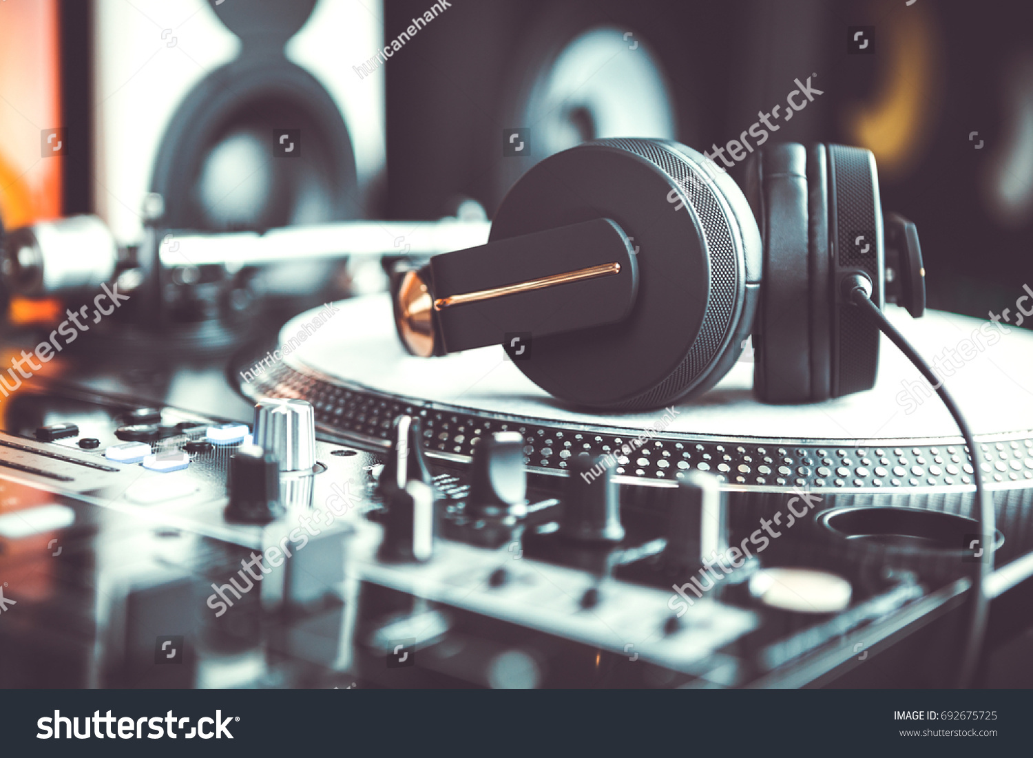 Dj headphones on turntable. Disc jockey audio equipment in close up #692675725