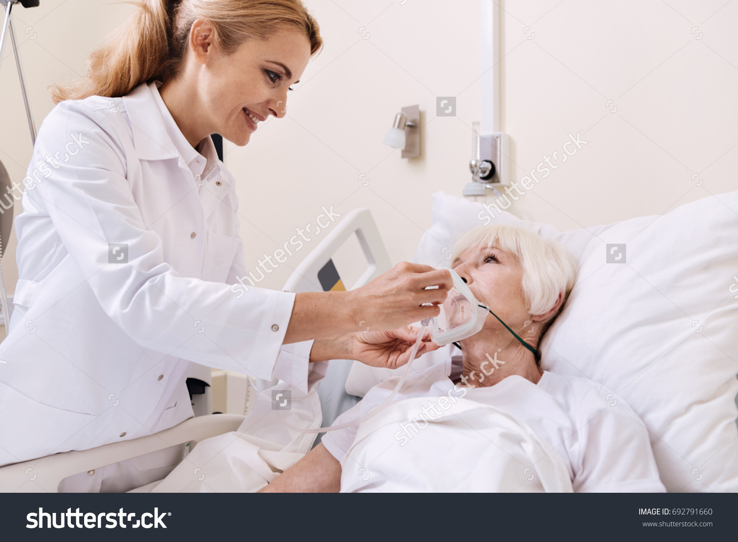 Competent friendly doctor talking to her elderly patient #692791660