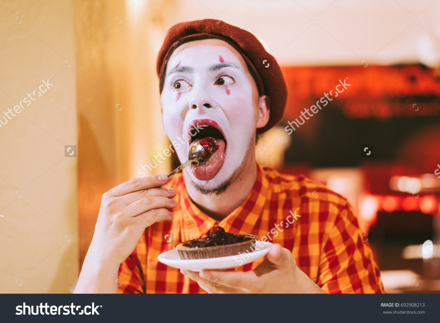 Mime eats cake in a cafe and croaks a face #692908213
