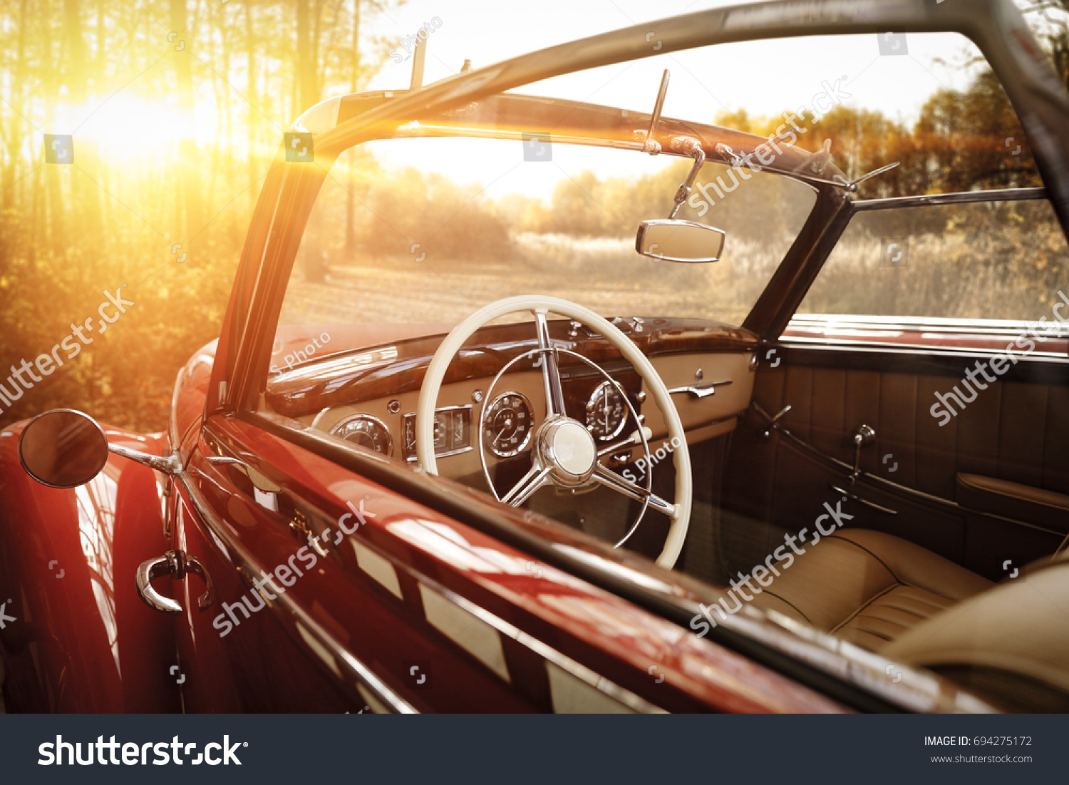 retro car in forest and golden autumn sunset time  #694275172