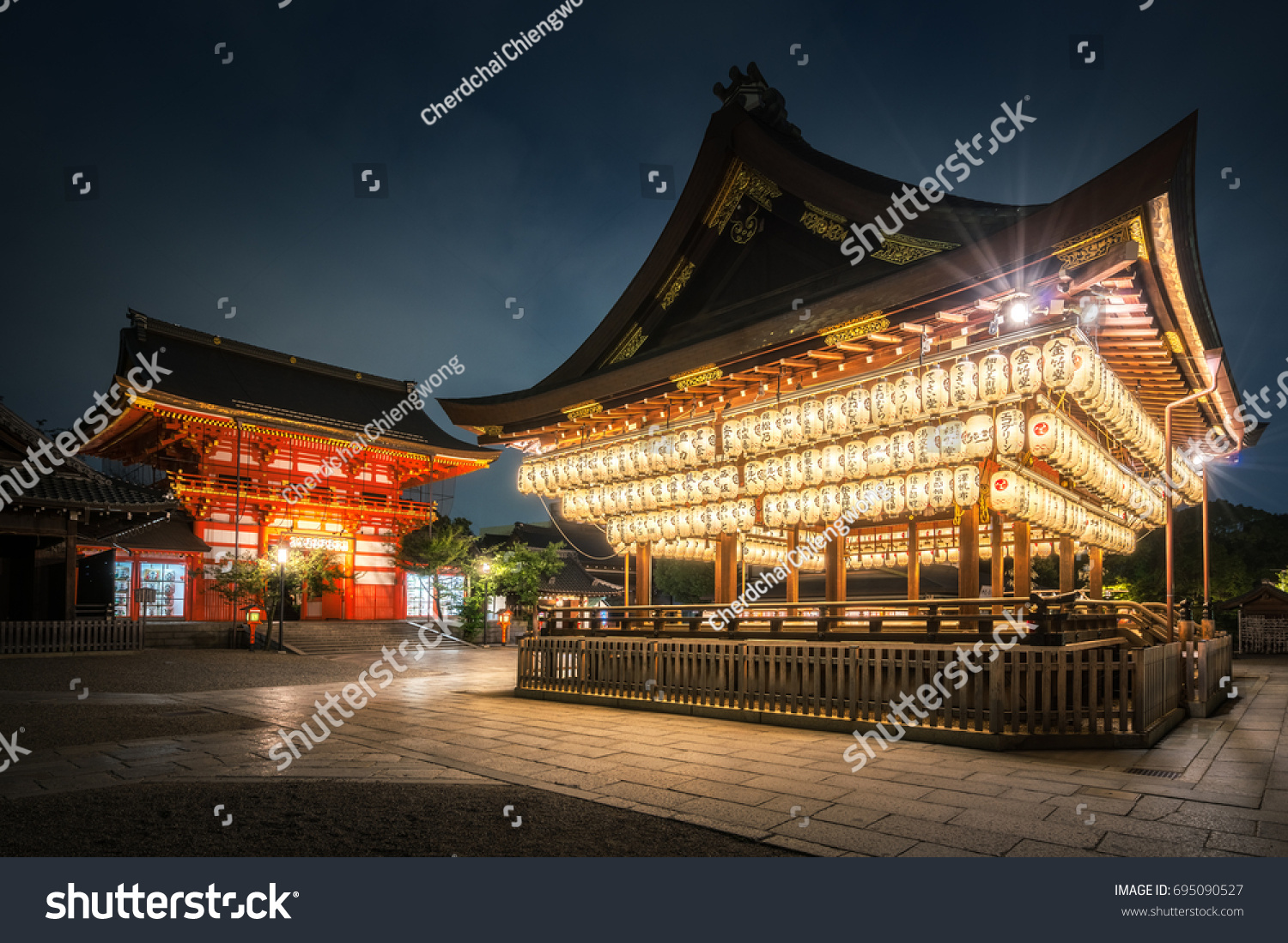 Yasaka shrine with a hundred of lanterns that light up at blue hour  #695090527
