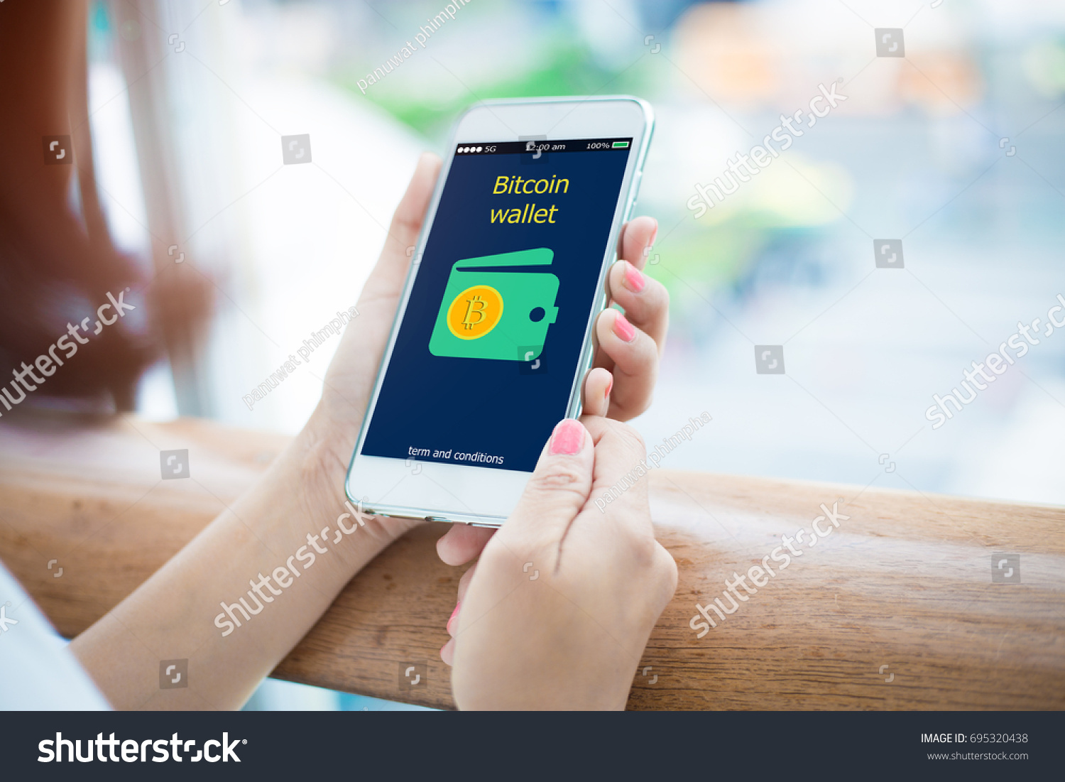 Bitcoin wallet.close-up of female hands holding mobile phone #695320438