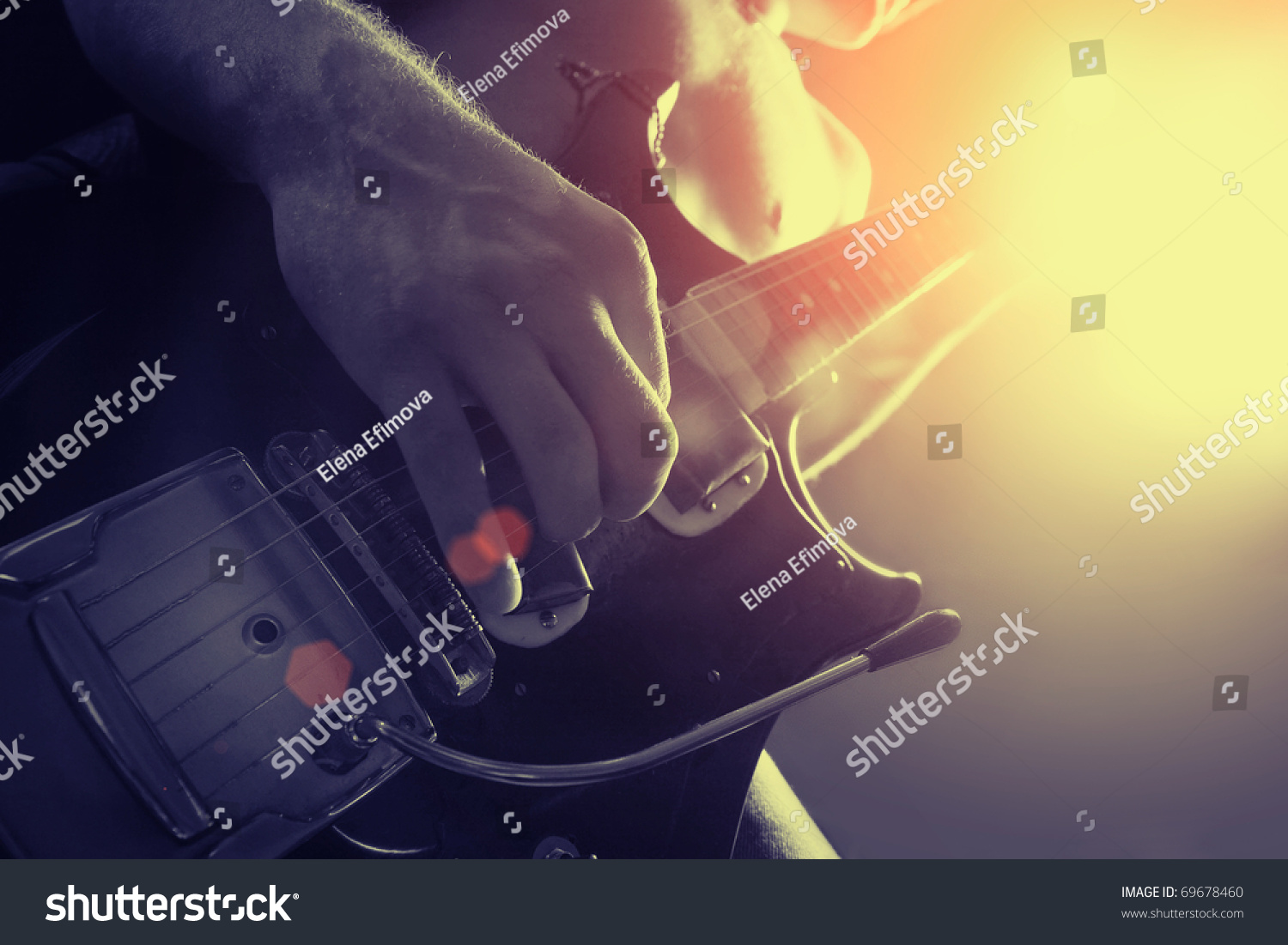 man playing electrical guitar in black and yellow #69678460