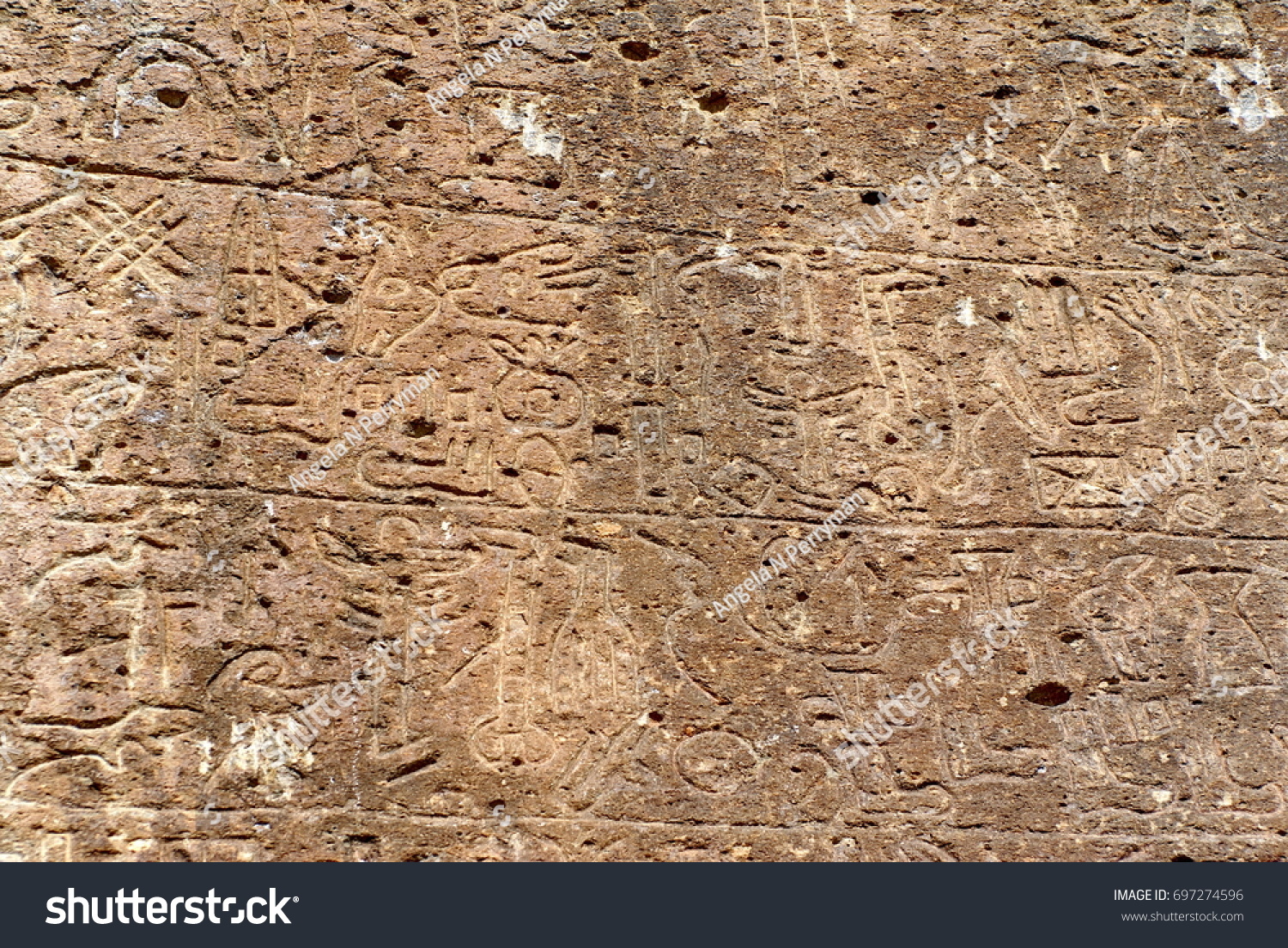 Hieroglyphs from the 8th century inscribed on a flat stone in Nevsehir province, Turkey #697274596