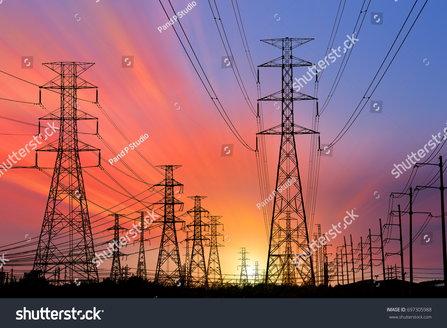 Silhouette High voltage electric tower on sunset time and sky on sunset time background. #697305988