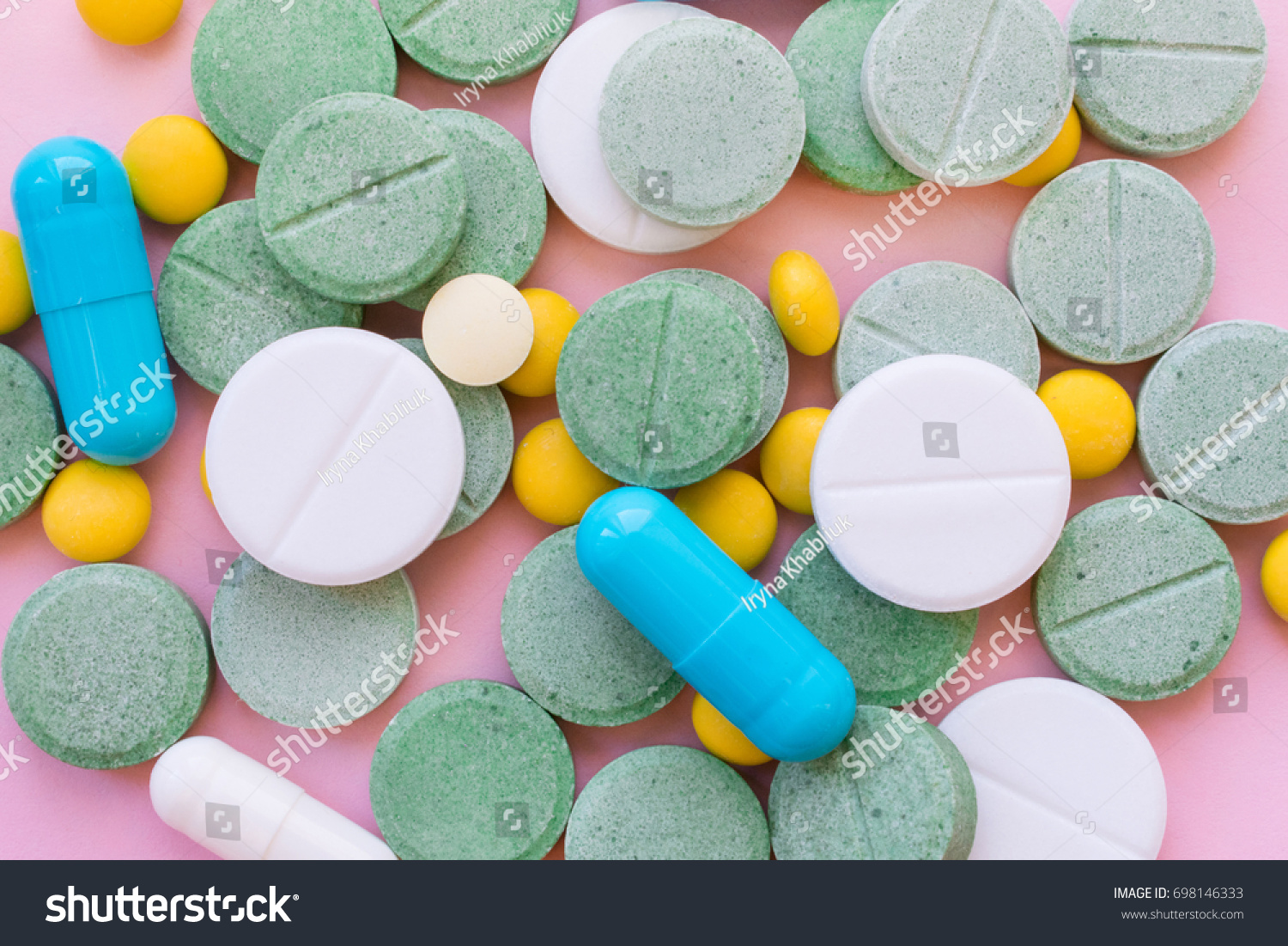 Opioid Pills. Opioid epidemic and drug abuse concept. Different tablets, pills, capsule on a pink background.  Heap mix therapy drugs.  #698146333