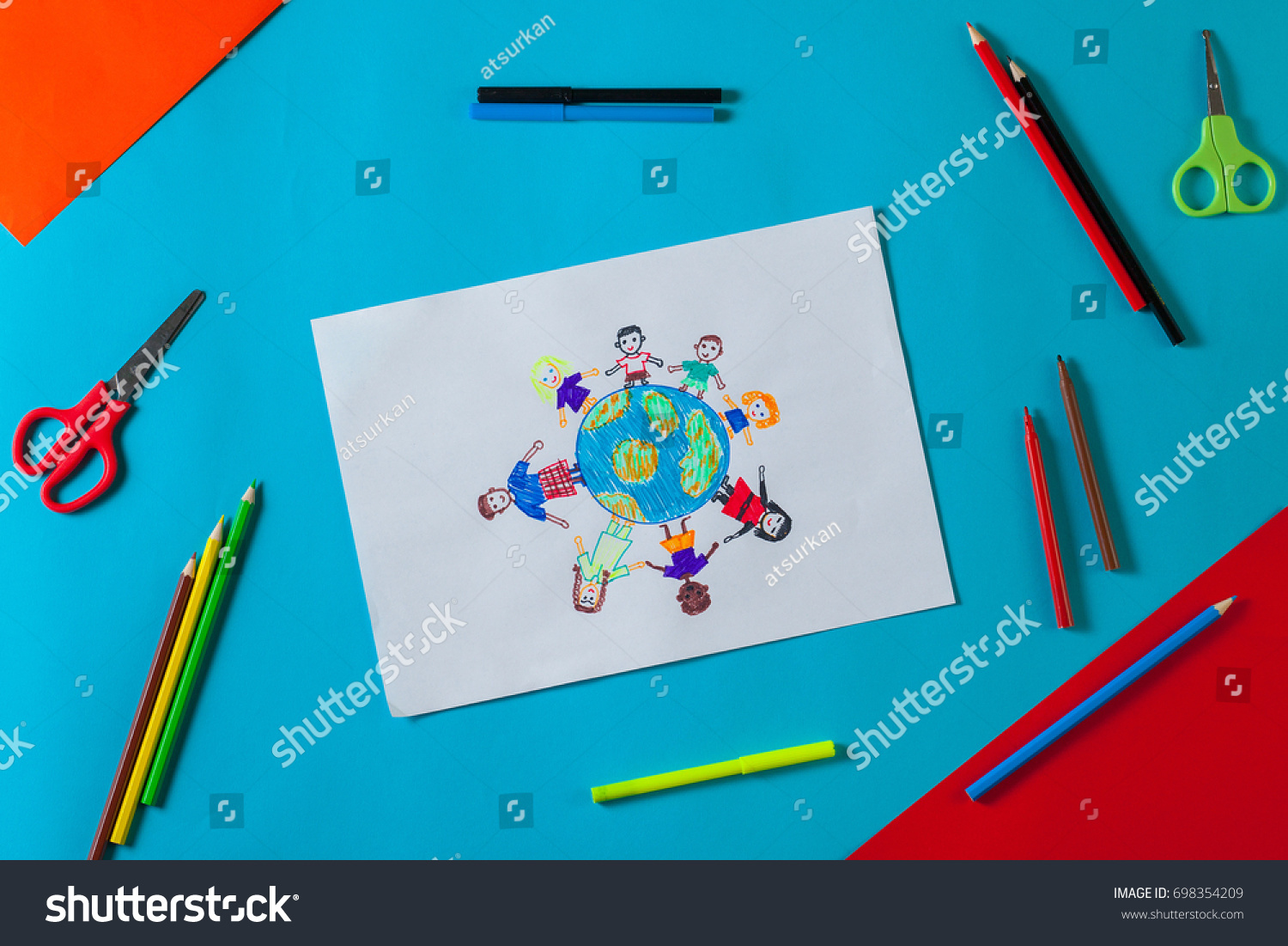 Kids draws with pencils and markers peace in the world. Child drawing the friendship of the peoples of the planet. Top view. #698354209