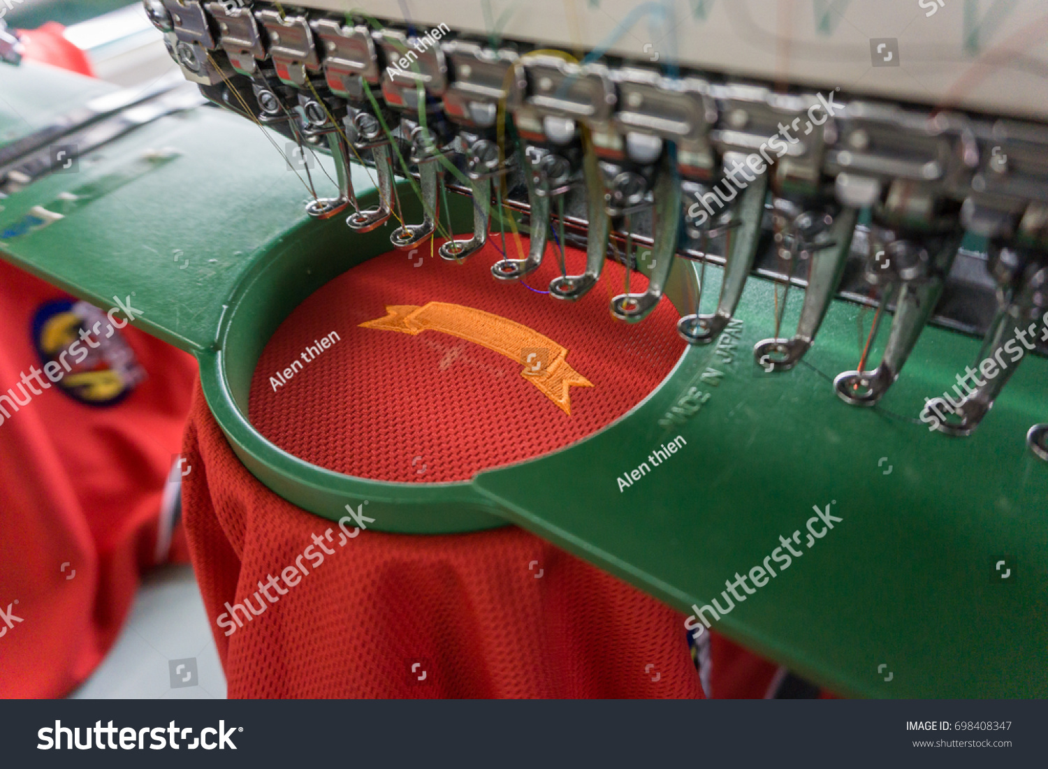 Embroidery machine needle in Textile Industry at Garment Manufacturers, Embroidery t-shirt in progress , Embroidery needle, Needle with thread (selective focus and soft focus) #698408347