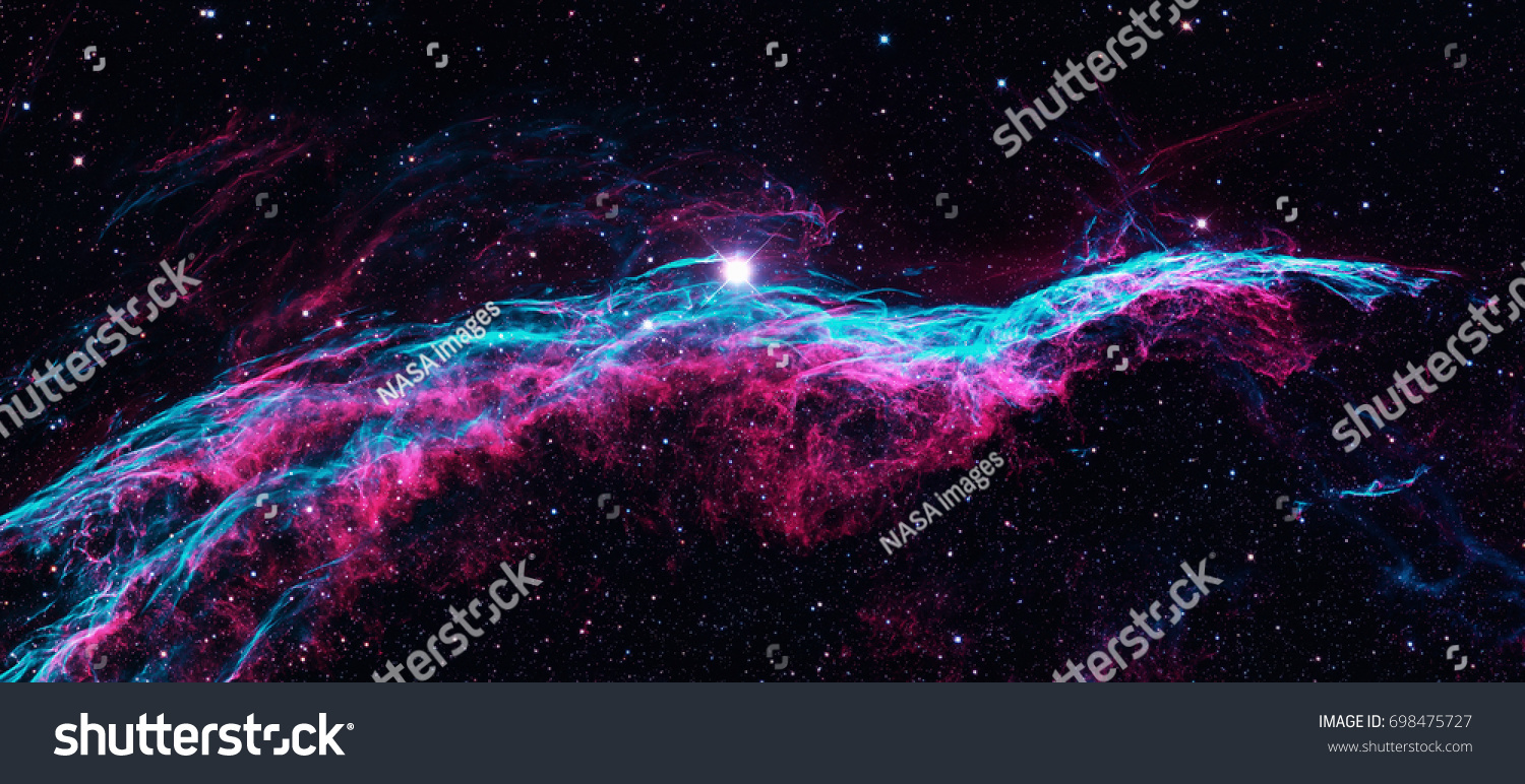 The Veil Nebula or The Witch's Broom Nebula is a cloud of heated and ionized gas and dust in the constellation Cygnus. Retouched colored image. Elements of this image furnished by NASA. #698475727