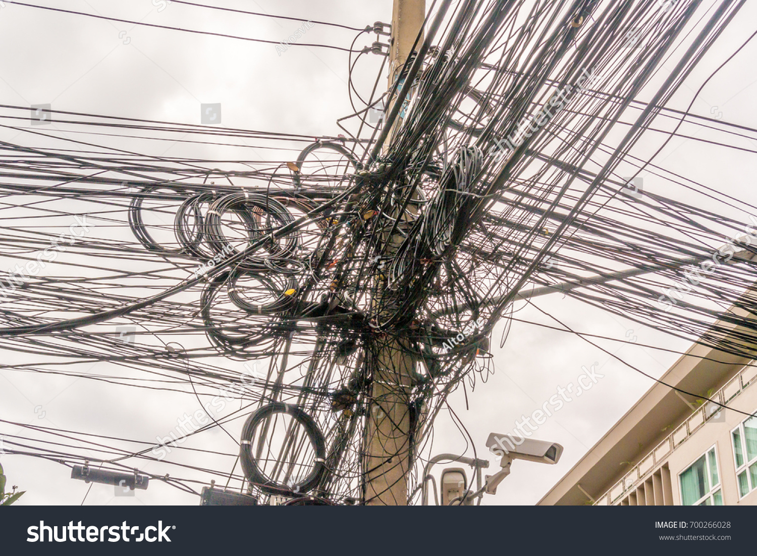 Grid of electric cables on the street of Thailand #700266028