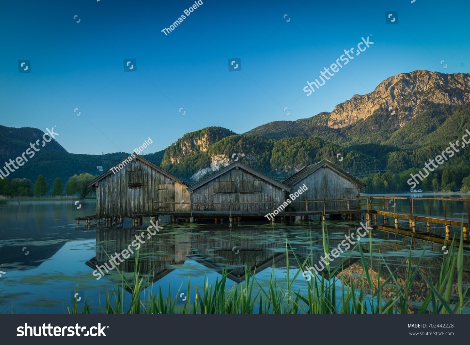 boatshouses on a lake #702442228