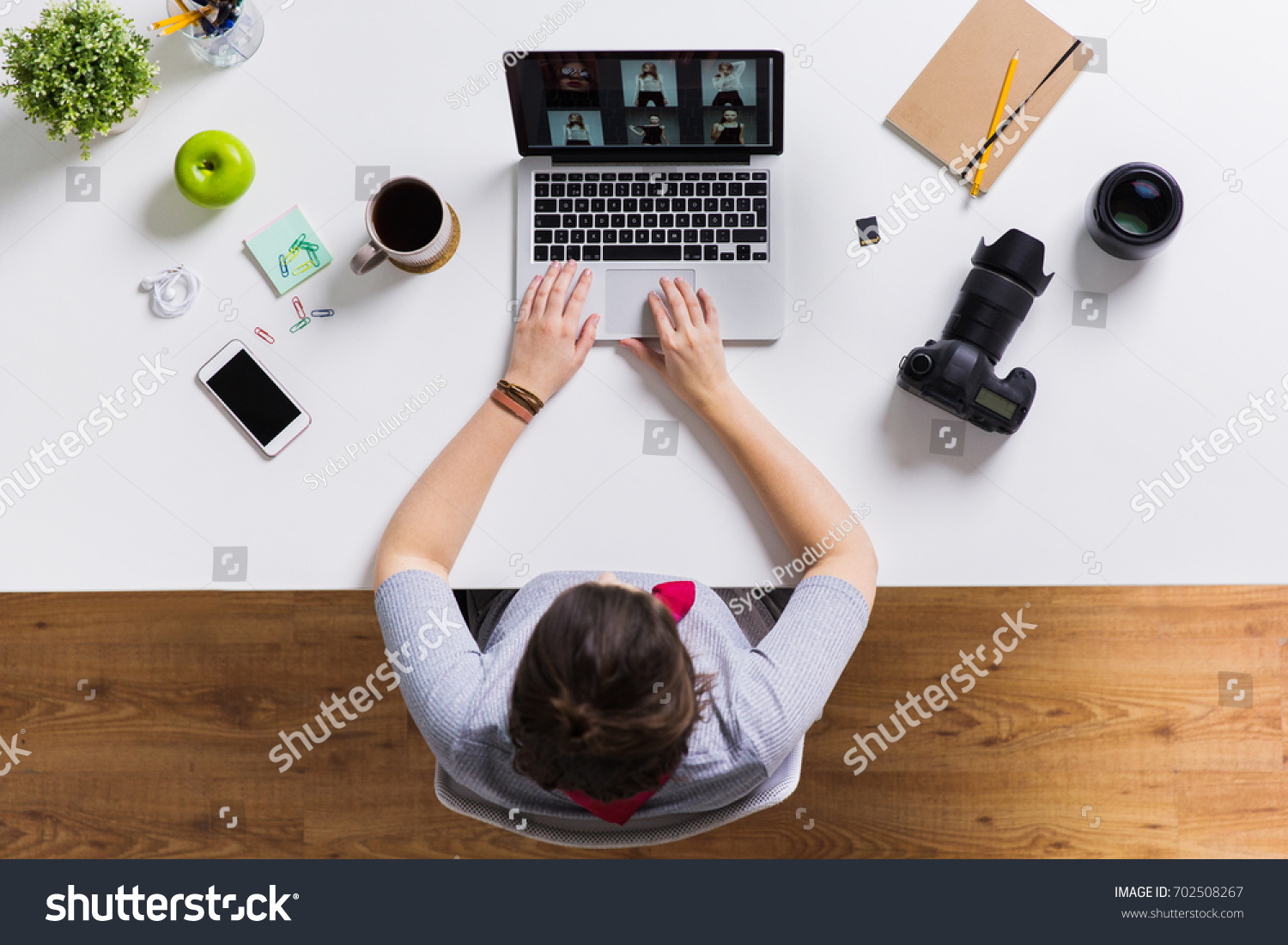 photography, people and technology concept - woman with camera working on laptop at table #702508267