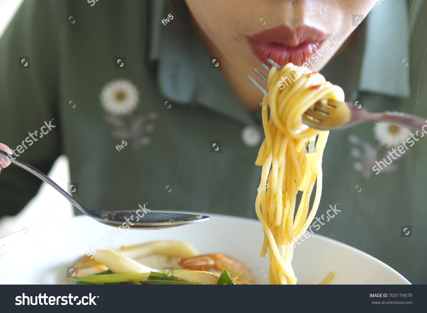 eating spaghetti with fork #703179979