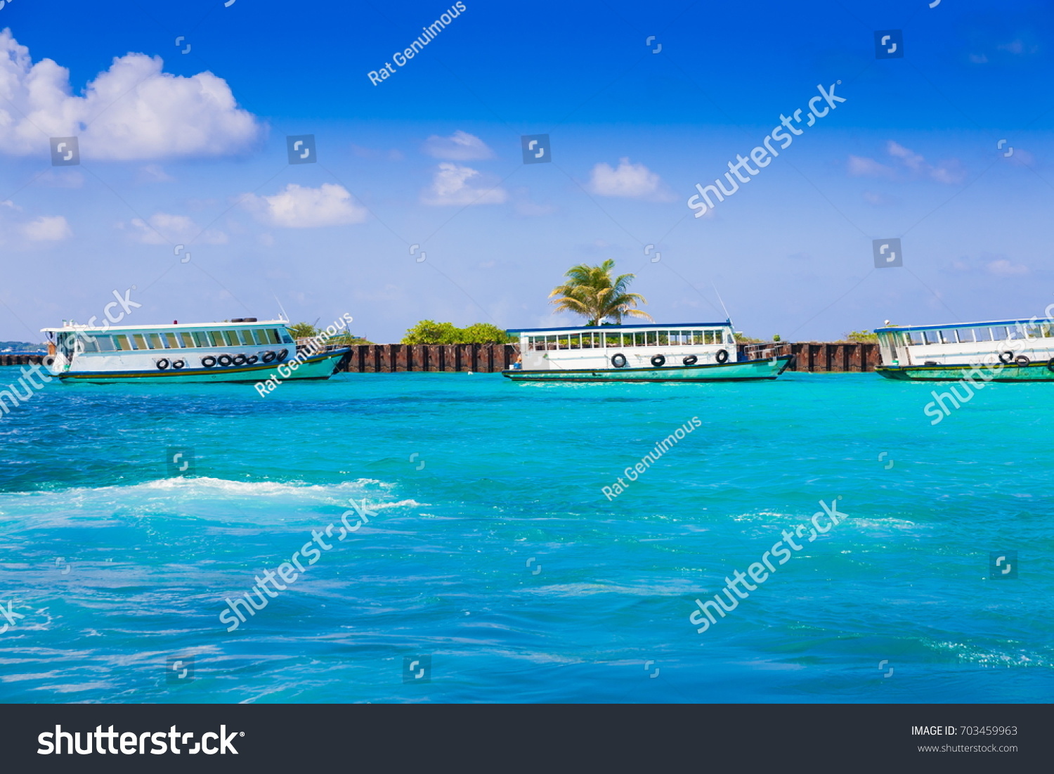 Tropical blue sea in island Male, country Maldives. Amazing nature landscape and boat. Wonderful luxury paradise. Beautiful exotic atoll.  Travel background.  Inspiration resort clear water.  #703459963