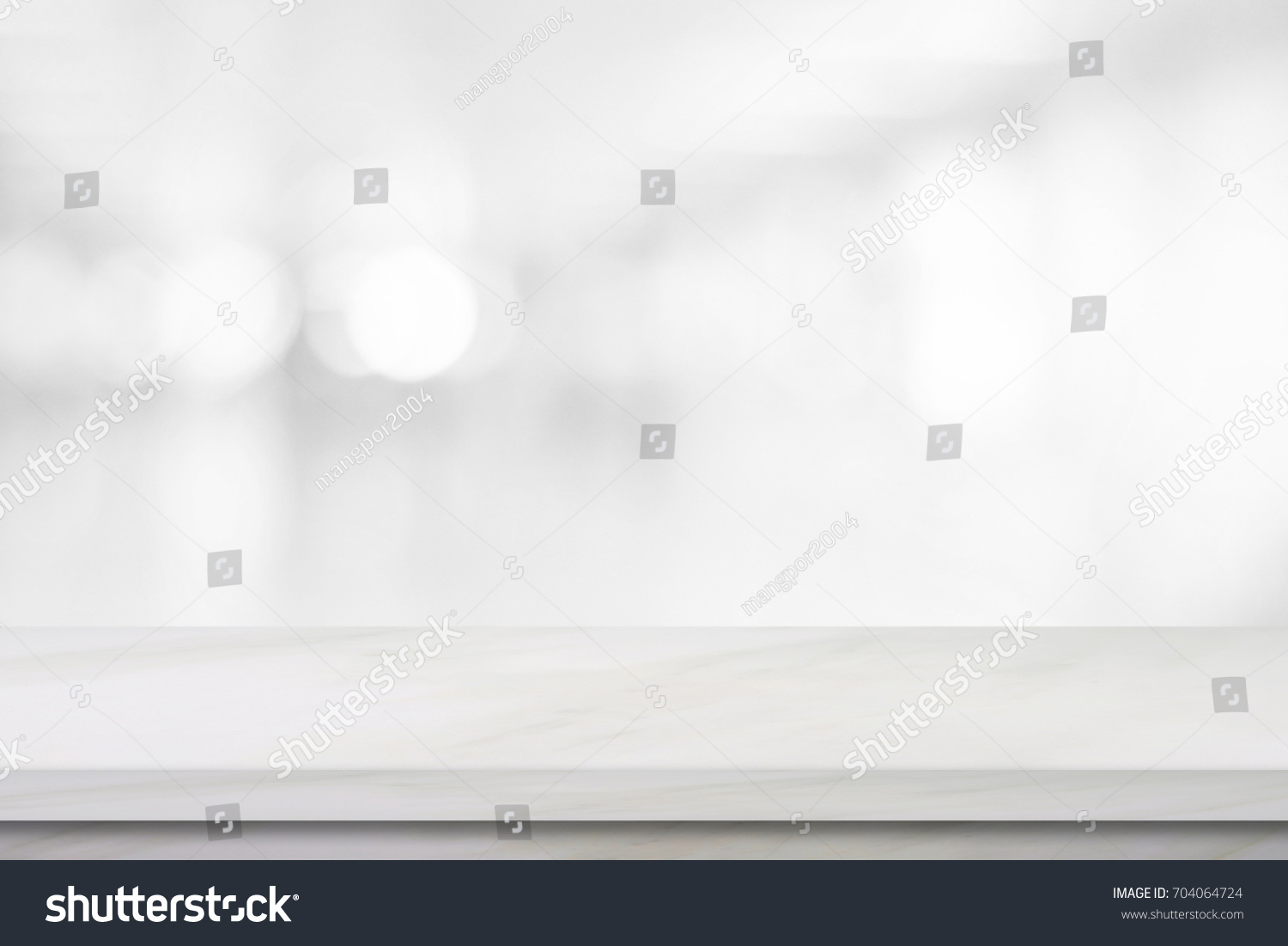 Empty white table top, counter, desk background over blur perspective bokeh light background, White marble stone table, shelf and blurred kitchen restaurant for food, product display mockup, template #704064724
